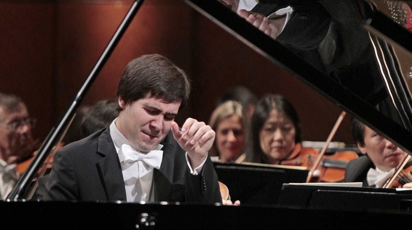 File - In this June 9, 2013 file photo, Vadym Kholodenko of Ukraine performs a concerto with the Fort Worth Symphony Orchestra during finals in the 14th Van Cliburn international piano competition in Fort Worth, Texas. Police say the two daughters of Kholodenko have been found slain in their Texas home and the musician's estranged wife is being treated for stab wounds. Benbrook police Cmdr. David Babcock said Friday, March 18, 2016 that Kholodenko is cooperating with investigators and that no on