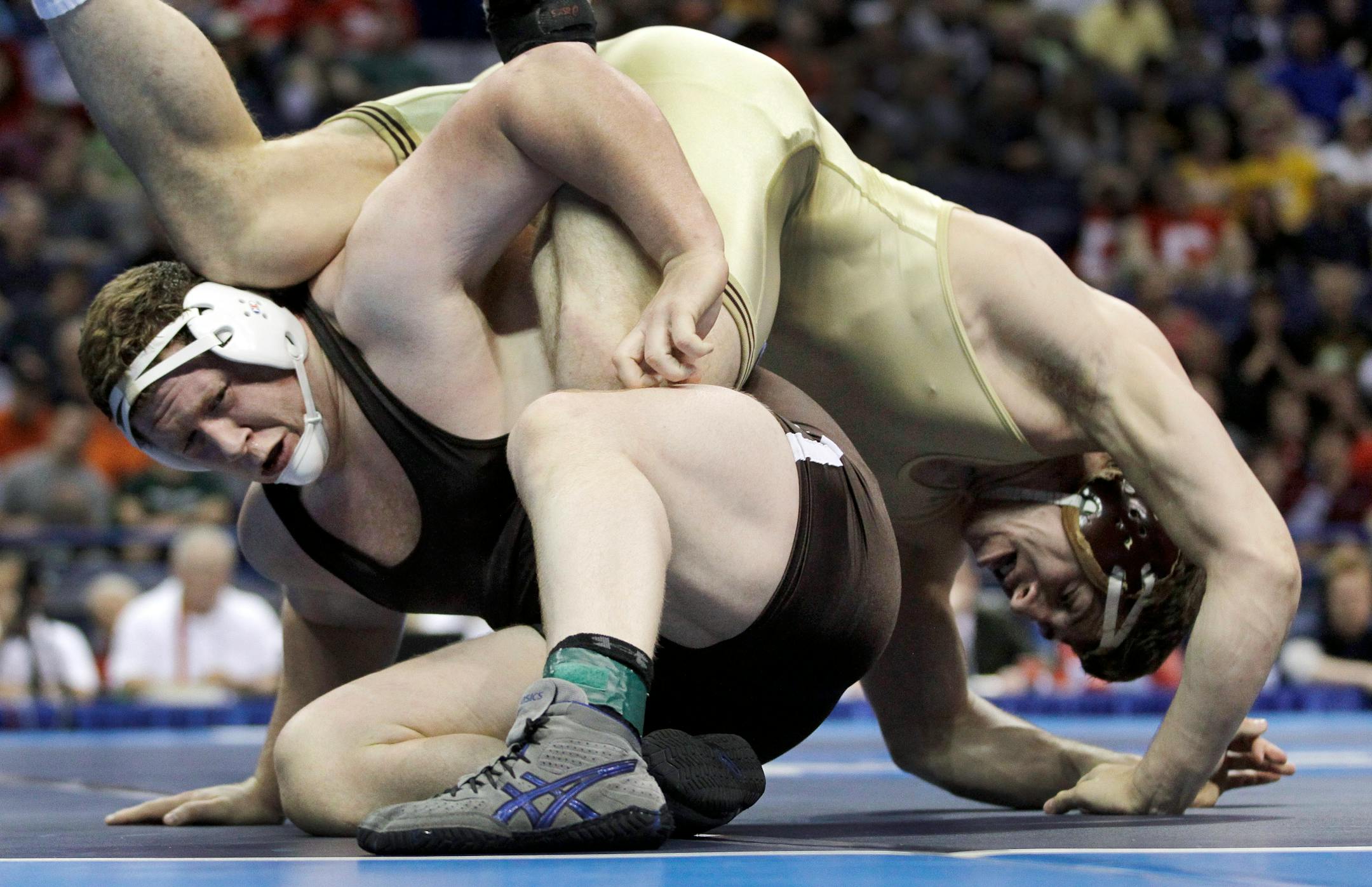 Lehigh's Zachery Rey, left, and Minnesota's Anthony Nelson wrestle during their 285-pound championship match, Saturday, March 17, 2012, at the NCAA Division I Wrestling Championships in St. Louis. (AP Photo/Jeff Roberson)