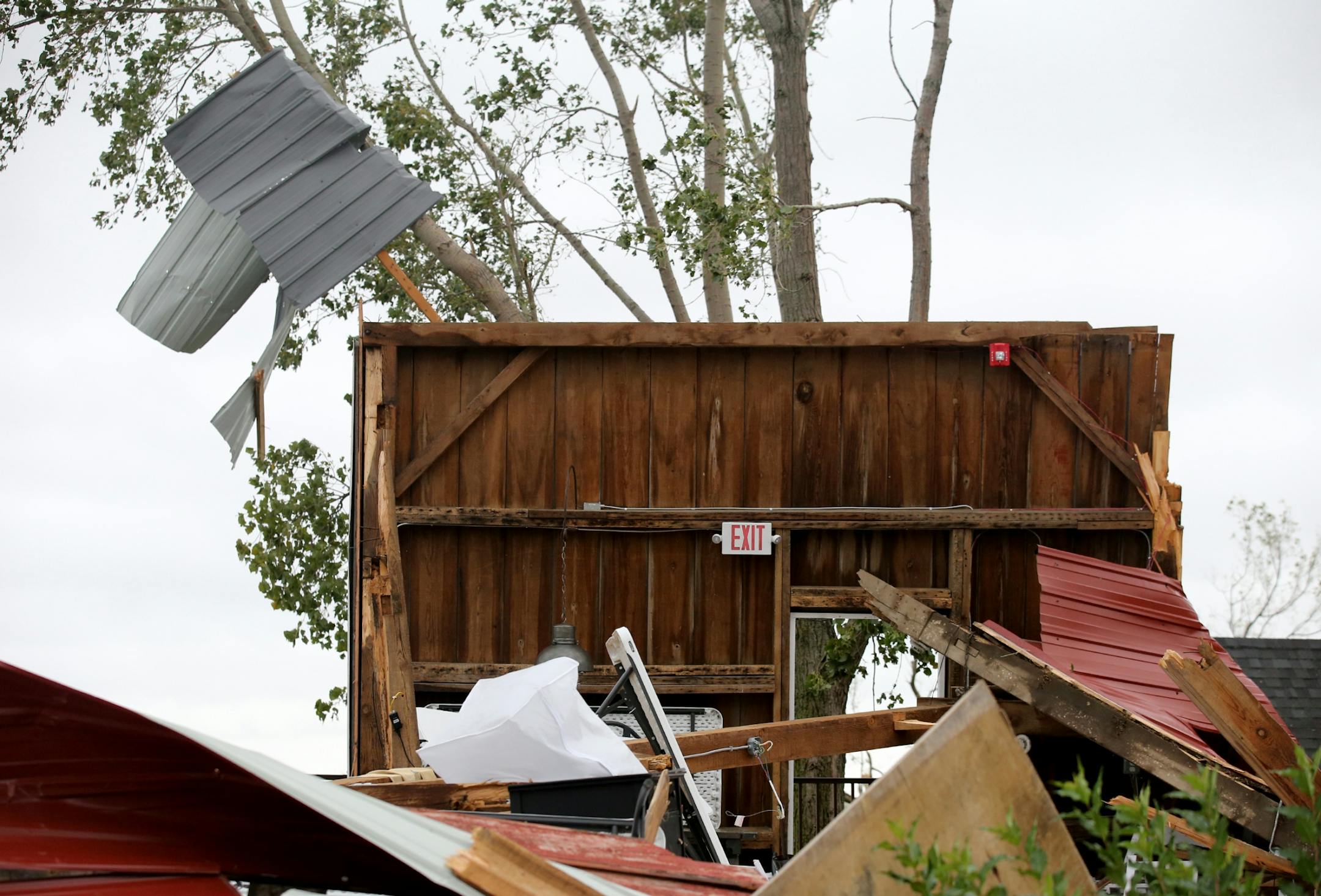 A portion of a wall remain upright at the Red Barn Farm of Northfied, destroyed by storms Thursday evening Friday, Sept. 21, 2018, in Northfield, MN. Members of the Winter family who own and run the wedding and pizza venue had been in the barn celebrating a birthday of a family member when the storm hit and destroyed the barn.