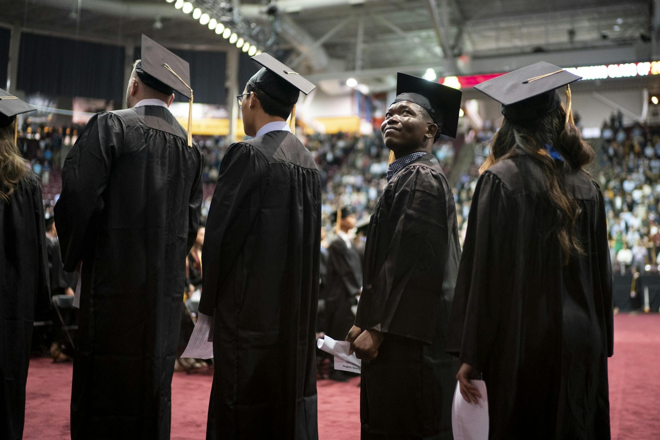 Lebene Geoffroy looked to the audience as he walked in the processional at the commencement for the College of Food, Agriculture, and Natural Sciences at the University of Minnesota in Minneapolis, Minn., on Friday, May 10, 2019. Geoffroy earned a degree in nutrition.