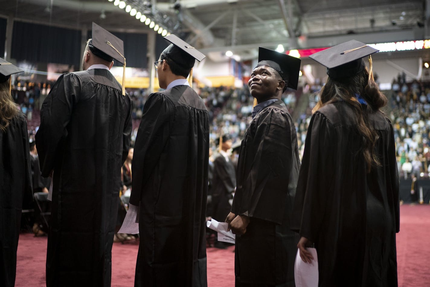 Lebene Geoffroy looked to the audience as he walked in the processional at the commencement for the College of Food, Agriculture, and Natural Sciences at the University of Minnesota in Minneapolis, Minn., on Friday, May 10, 2019. Geoffroy earned a degree in nutrition.