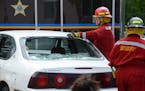 Mike Hubred, a volunteer with the Hennepin County Sheriff's Office Special Deputy program, demonstrates how to rescue passengers from a smashed car du