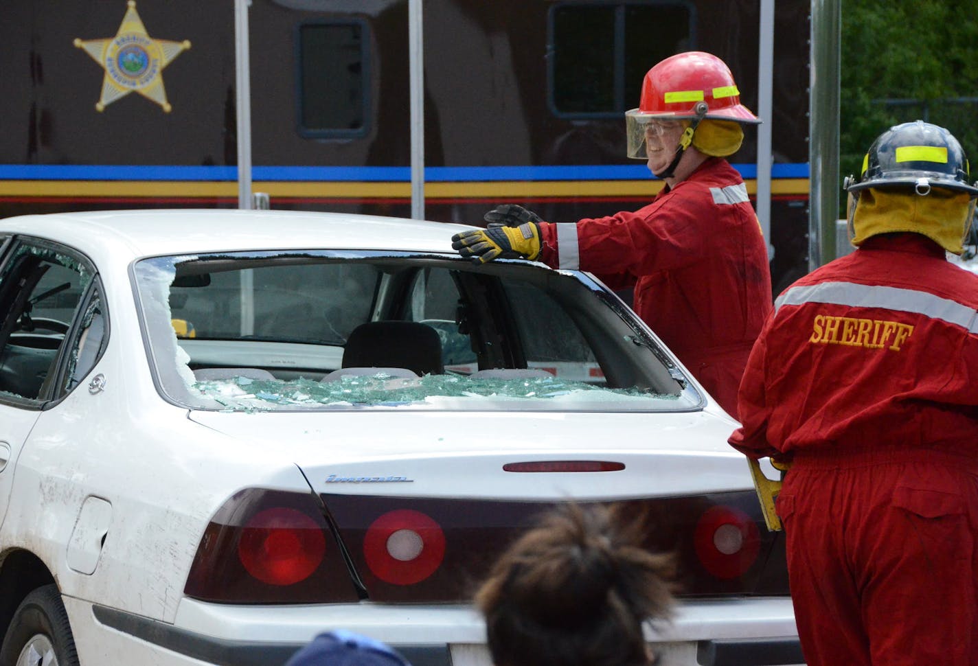 Mike Hubred, a volunteer with the Hennepin County Sheriff's Office Special Deputy program, demonstrates how to rescue passengers from a smashed car during an open house. The Special Deputy program currently has 93 volunteers.