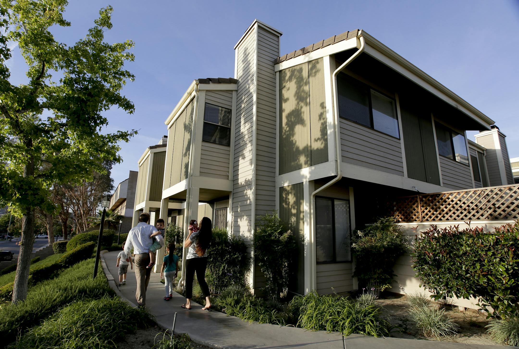 FILE - In this Monday, May 11, 2015, file photo, first-time home buyer Brett Singley, his wife Angelynn, and their children walk to their condo in Santa Clarita, Calif. On Thursday, June 1, 2017, Freddie Mac reports on the weekís average U.S. mortgage rates. (AP Photo/Chris Carlson, File)