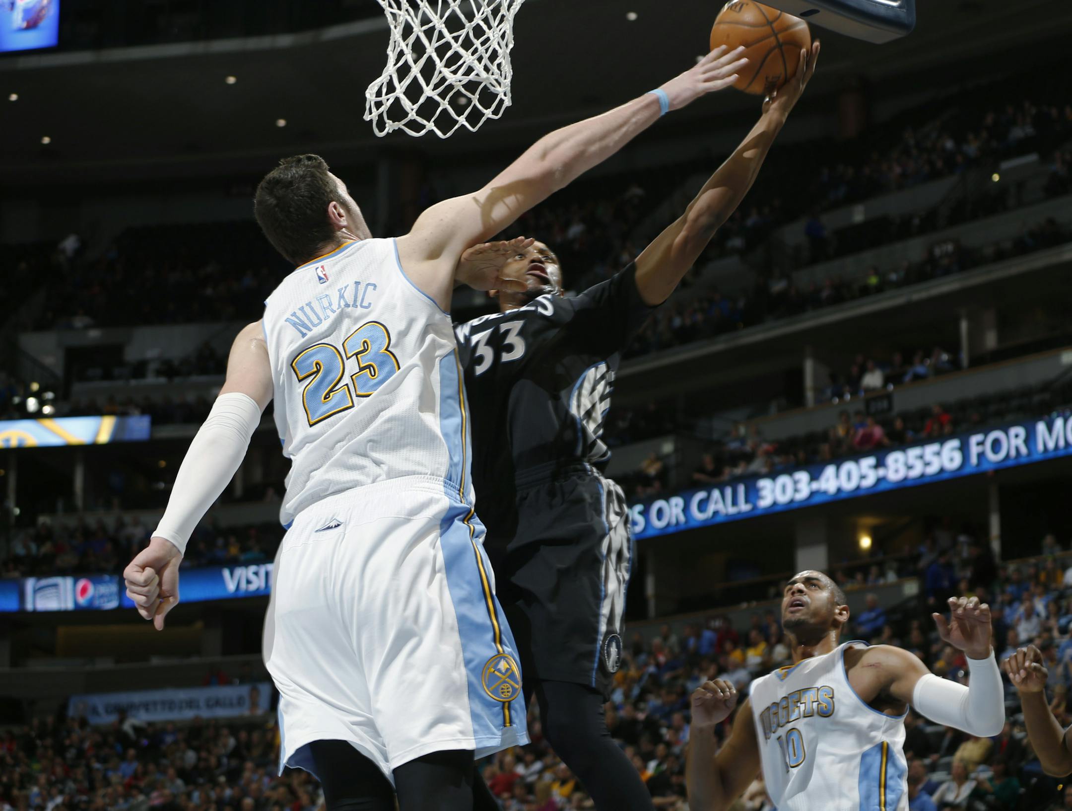 Denver Nuggets center Jusuf Nurkic, left, blocks a shot by Minnesota Timberwolves forward Thaddeus Young in the first quarter of an NBA basketball game Saturday, Jan. 17, 2015, in Denver. (AP Photo/David Zalubowski)