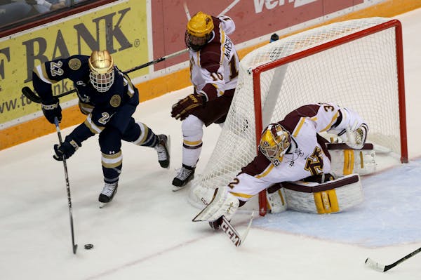 Gopher's goalie Adam Wilcox tried to block the shot of Notre Dame's Mario Lucia in 2014. The teams will be conference rivals beginning in 2017.