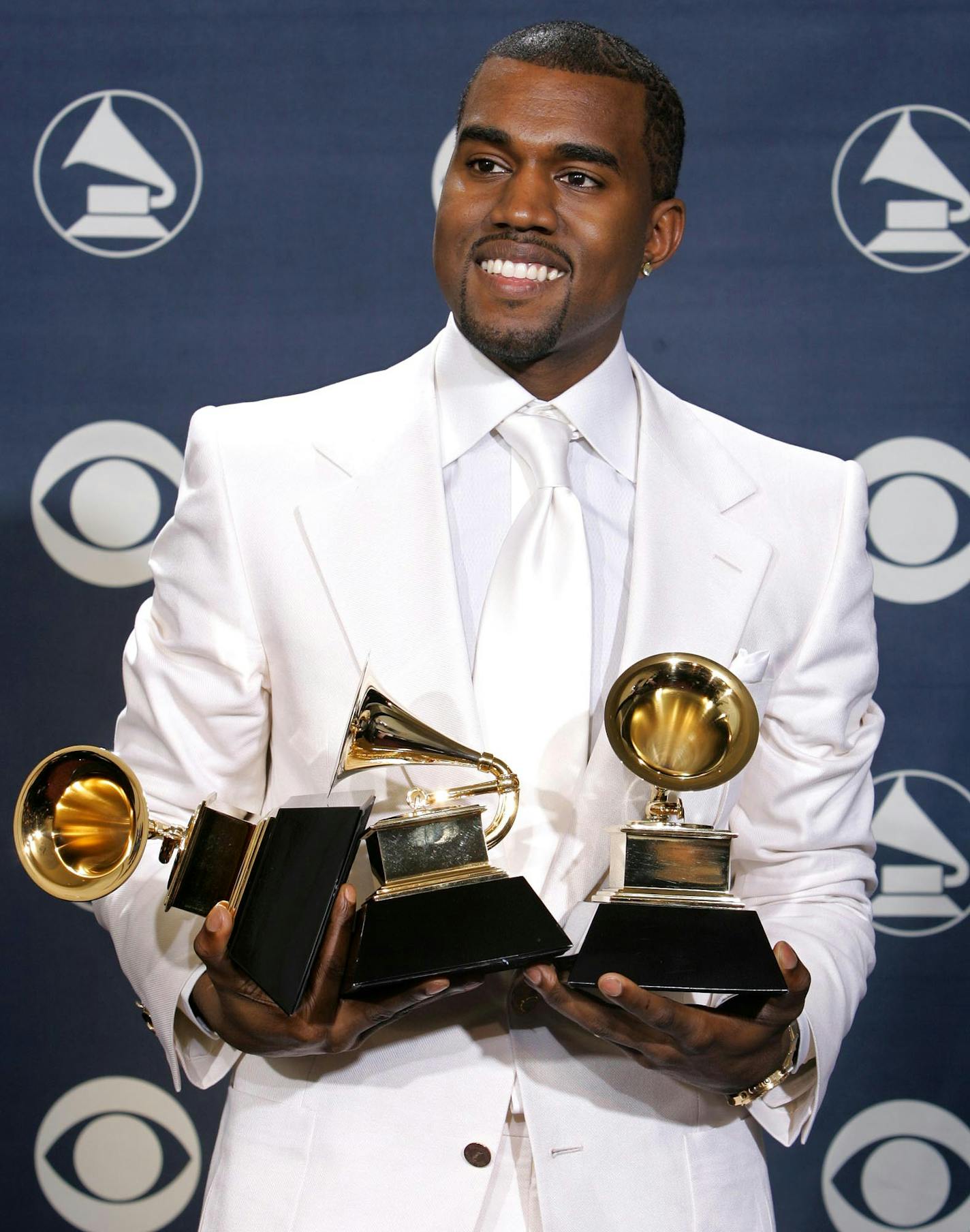 Kanye West poses with his three awards at the 47th Annual Grammy Awards in February 2005 at the Staples Center in Los Angeles.