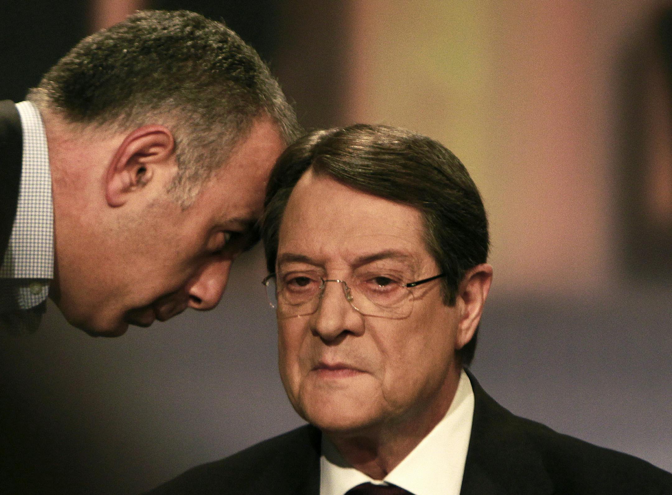 CORRECTS DATE - Right-wing opposition leader Nicos Anastasiades talk with a journalist before the start of live televised debate between candidates Anastasiades and left-wing party Stavros Malas, unseen, in capital Nicosia, Cyprus, Friday, Feb. 22, 2013. The conservative candidate Nicos Anastasiades in Cyprusí election runoff Sunday, Feb. 24, looks poised to become the crisis-hit countryís new president charged with swiftly negotiating a rescue package with international creditors, ana