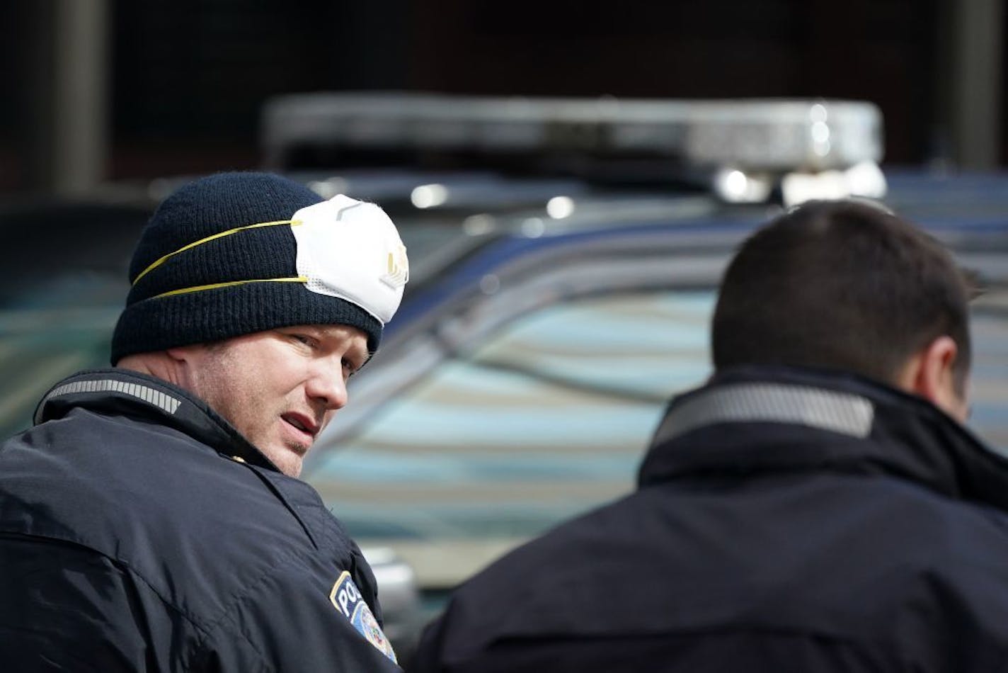 A Metro Transit police officer wore a protective N95 mask on his head as he and other officer answered a call Saturday on Nicollet Mall.