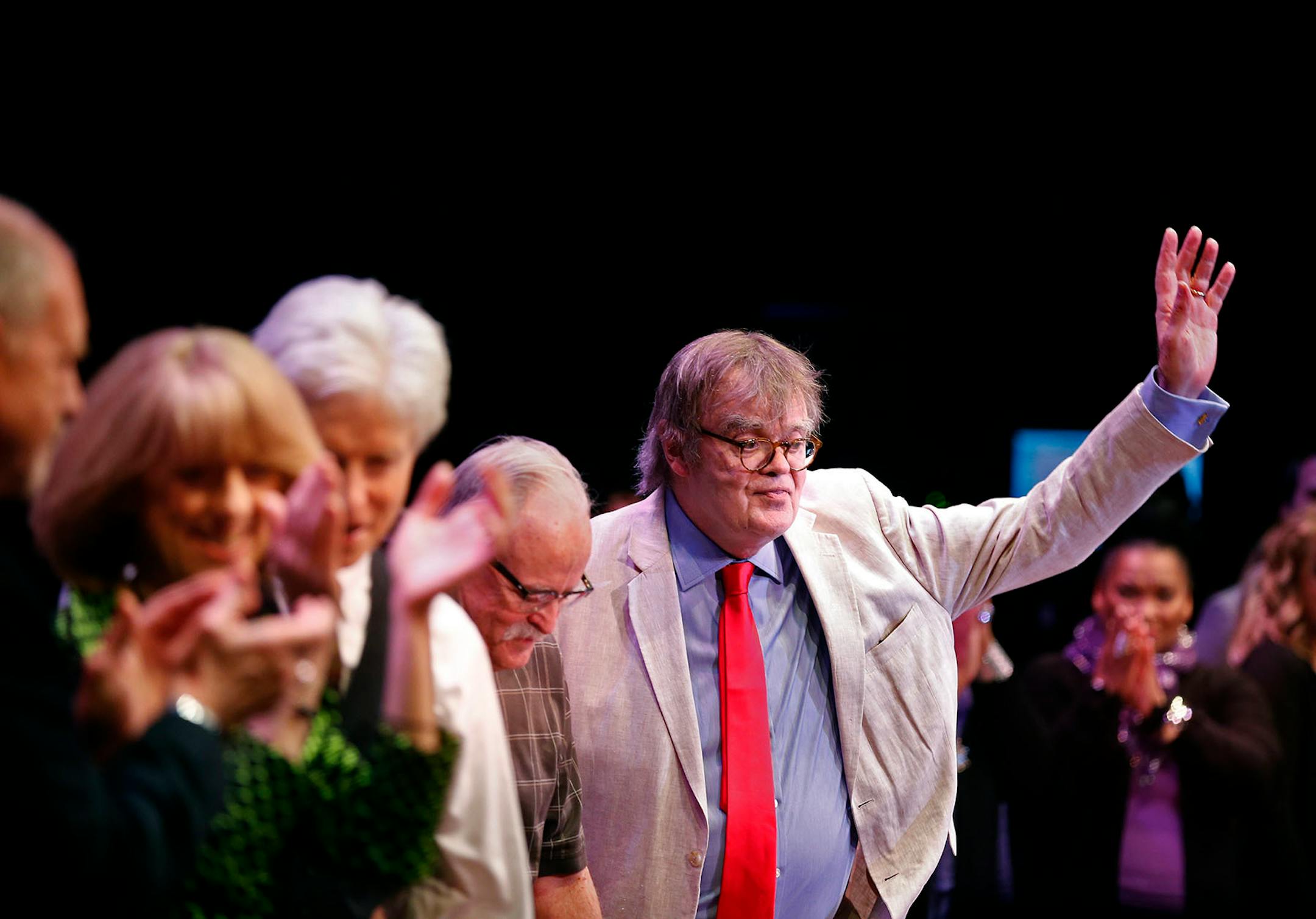 Garrison Keillor waves to the audience after the show at the State Theatre.