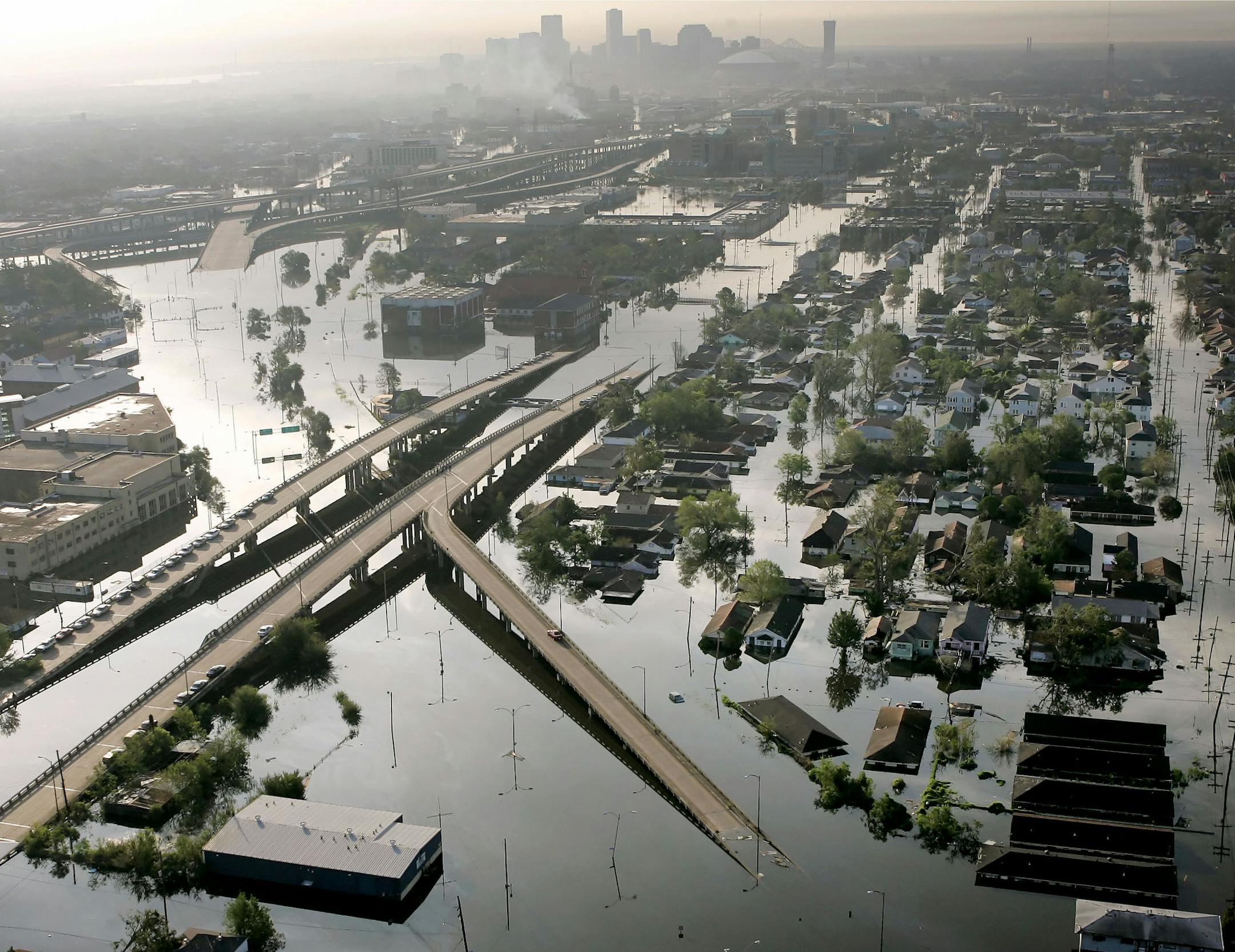 FILE - In this Aug. 30, 2005 file photo, floodwaters from Hurricane Katrina fill the streets near downtown New Orleans. Tourism in New Orleans has rebounded in the 10 years since the levees broke, flooding the city. (AP Photo/David J. Phillip, File)