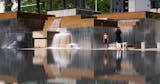 A young boy stopped playing briefly to have his photo taken in front of the fountains at Peavey Plaza as they flowed over the reflecting pool Thursday. ] ANTHONY SOUFFLE &#x2022; anthony.souffle@startribune.com Peavey Plaza's fountains are flowing again following after a $10 million restoration photographed Thursday, Aug. 8, 2019 in Minneapolis.