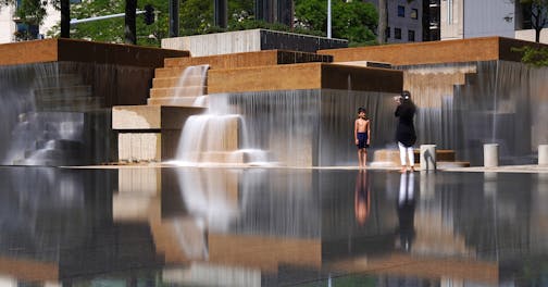A young boy stopped playing briefly to have his photo taken in front of the fountains at Peavey Plaza as they flowed over the reflecting pool Thursday. ] ANTHONY SOUFFLE &#x2022; anthony.souffle@startribune.com Peavey Plaza's fountains are flowing again following after a $10 million restoration photographed Thursday, Aug. 8, 2019 in Minneapolis.