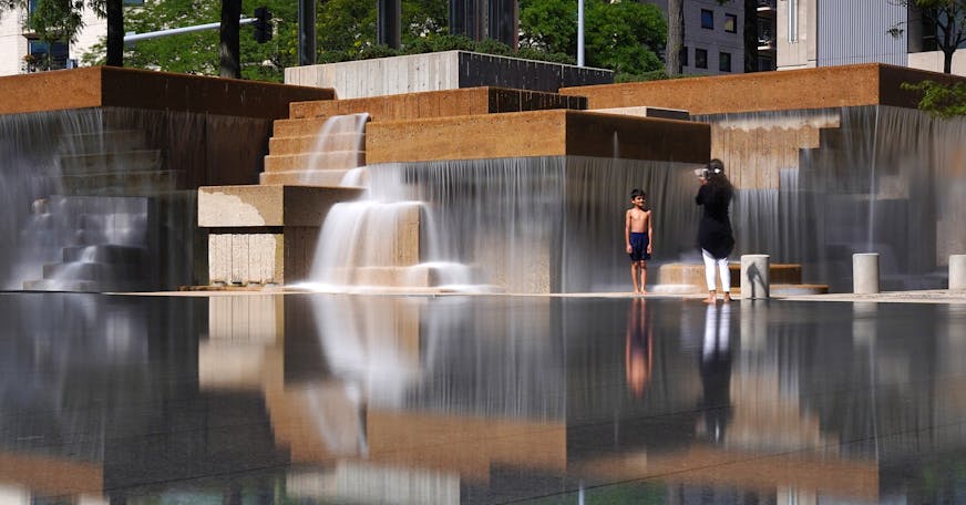 A young boy stopped playing briefly to have his photo taken in front of the fountains at Peavey Plaza as they flowed over the reflecting pool Thursday. ] ANTHONY SOUFFLE &#x2022; anthony.souffle@startribune.com Peavey Plaza's fountains are flowing again following after a $10 million restoration photographed Thursday, Aug. 8, 2019 in Minneapolis.