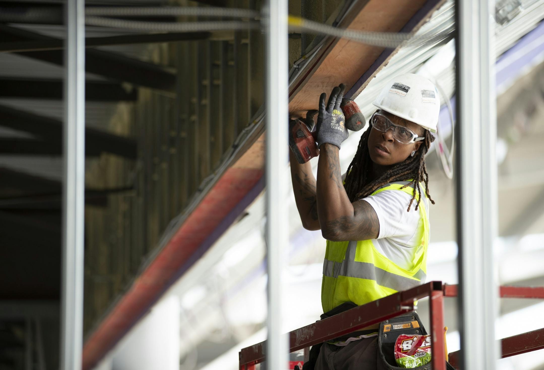 Carmen Richardson, a carpenter with M.A. Mortenson Co. for the past eight years, fitted a board before securing it with screws to the piece behind it while working at Allianz Stadium this week.