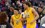 Gophers center Reggie Lynch (22) and guard Nate Mason (2) reacted as they left the court after a victory over Michigan State in the Big Ten tournament