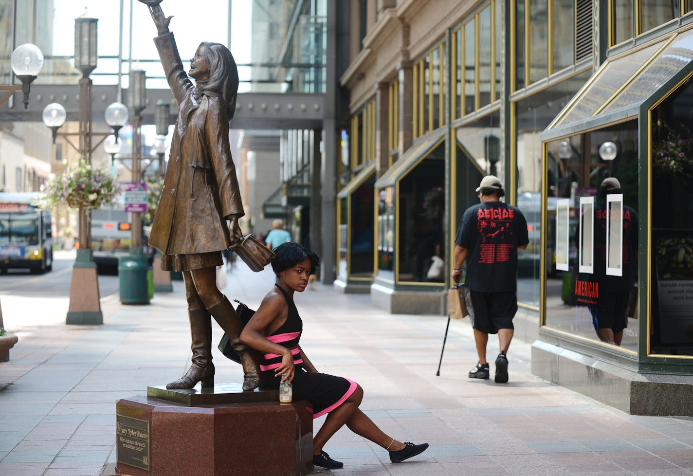 Shilita Clark, of Minneapolis, sat on The Mary Tyler Moore statue on Nicollet Mall in Minneapolis, Minn., on Saturday June 27, 2015. ] RACHEL WOOLF &#x2211; rachel.woolf@startribune.com