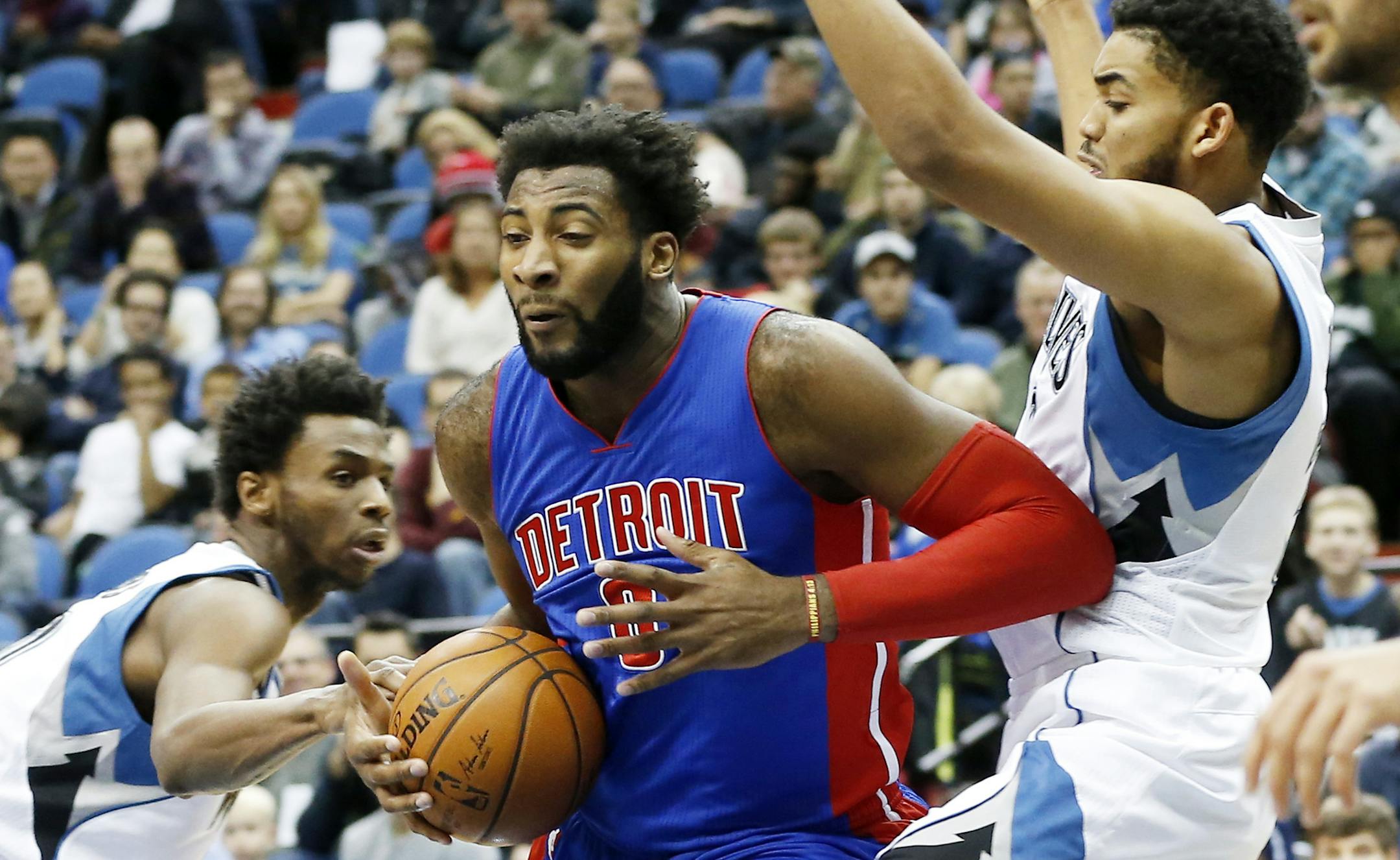 Detroit Pistonsí Andre Drummond, center, is defended by Minnesota Timberwolvesí Andrew Wiggins, left, and Karl-Anthony Towns, right, in the second half of an NBA basketball game, Friday, Nov. 20, 2015, in Minneapolis. The Pistons won 96-86. Drummond led the Pistons with 21 points and had 11 rebounds while Wiggins led the Timberwolves with 21 also. (AP Photo/Jim Mone)
