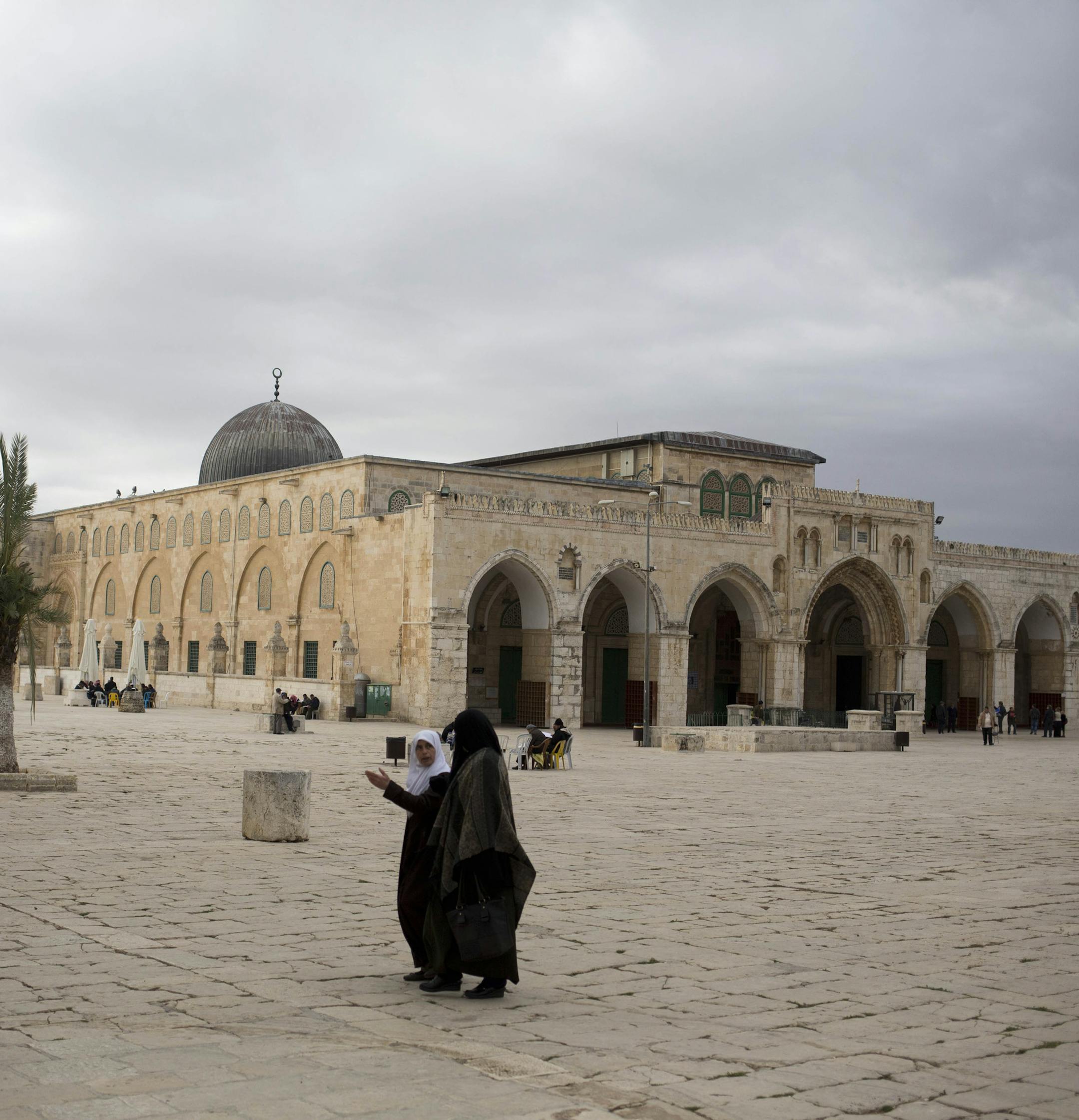 In this photo taken on Monday, Jan. 27, 2014, Palestinian women walk at the al-Aqsa mosque compound in Jerusalem. The mosque's library has a collection of some 4,000 old manuscripts with about a quarter considered in poor condition. Half of the books are already undergoing restoration funded by the Waqf, Jordanís Islamic authority which manages the holy site, and with assistance from UNESCO. (AP Photo/Dusan Vranic)