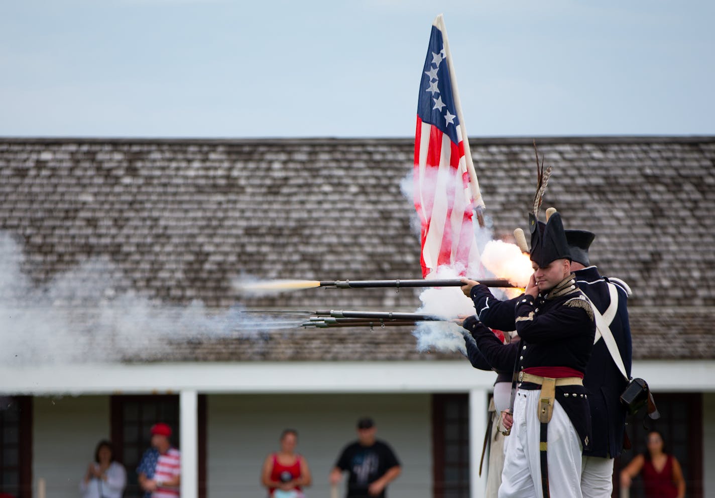 War re-enactors fire blanks from their muskets during a re-enactment of a battle from the War of 1812 on the Fourth of July. ] ALEX KORMANN &#xa5; alex.kormann@startribune.com Historic Fort Snelling played host to their annual Fourth of July celebration. Despite a morning full of heavy rain, war re-enactors still raised the American flag and soon the rain gave way and the festivities went into full swing. The day's events included an infantry parade, musket firing, battle re-enactment and canon