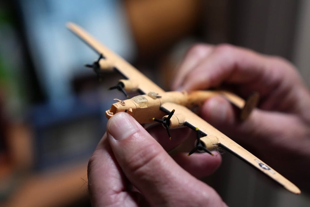 Steve Eide held a toy model of the plane his father flew in during the war. Jim Eide enlisted with the Army Air Corps because he loved model airplanes.