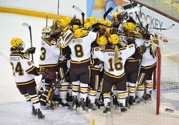 Minnesota players mob goalie Amanda Raty after beating Cornell 3-1 in an NCAA women's college Frozen Four hockey game in Duluth, MInn., Friday March 1