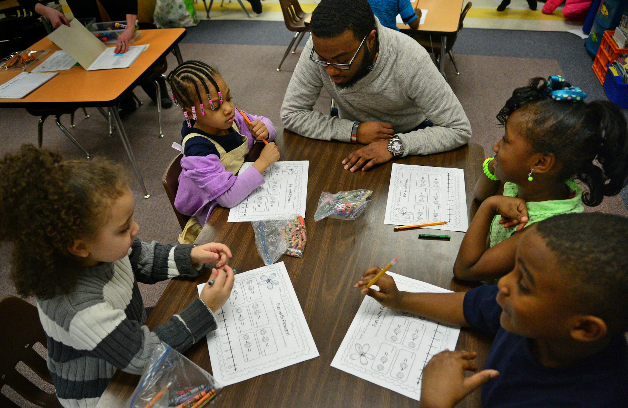 Jayden Myles is a navigator which is like a mentor who works with students in the NAZ program. He works with these young scholars one on one focusing on strengths and weaknesses of students while building esteem and improving academic outcomes. ] Nellie Stone Johnson Community School is in the Northside Achievement Zone. Richard.Sennott@startribune.com Richard Sennott/Star Tribune Minneapolis , Minn.Wednesday 3/26/2014) ** (cq)
