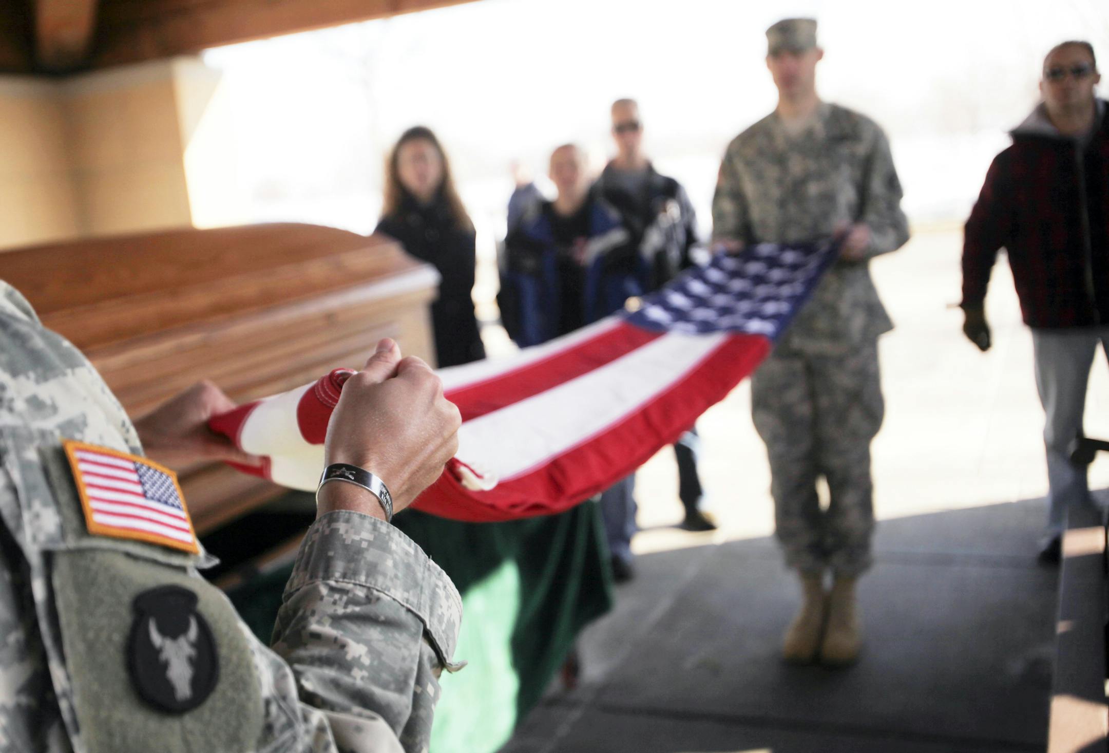 Sgt. Erik Soge, left, and Staff Sgt. Chad Minette, second from right, practiced folding a flag for a military funeral along with other members of the Minnesota National Guard Military Funeral Honor Guard Team at Fort Snelling Cemetery recently.