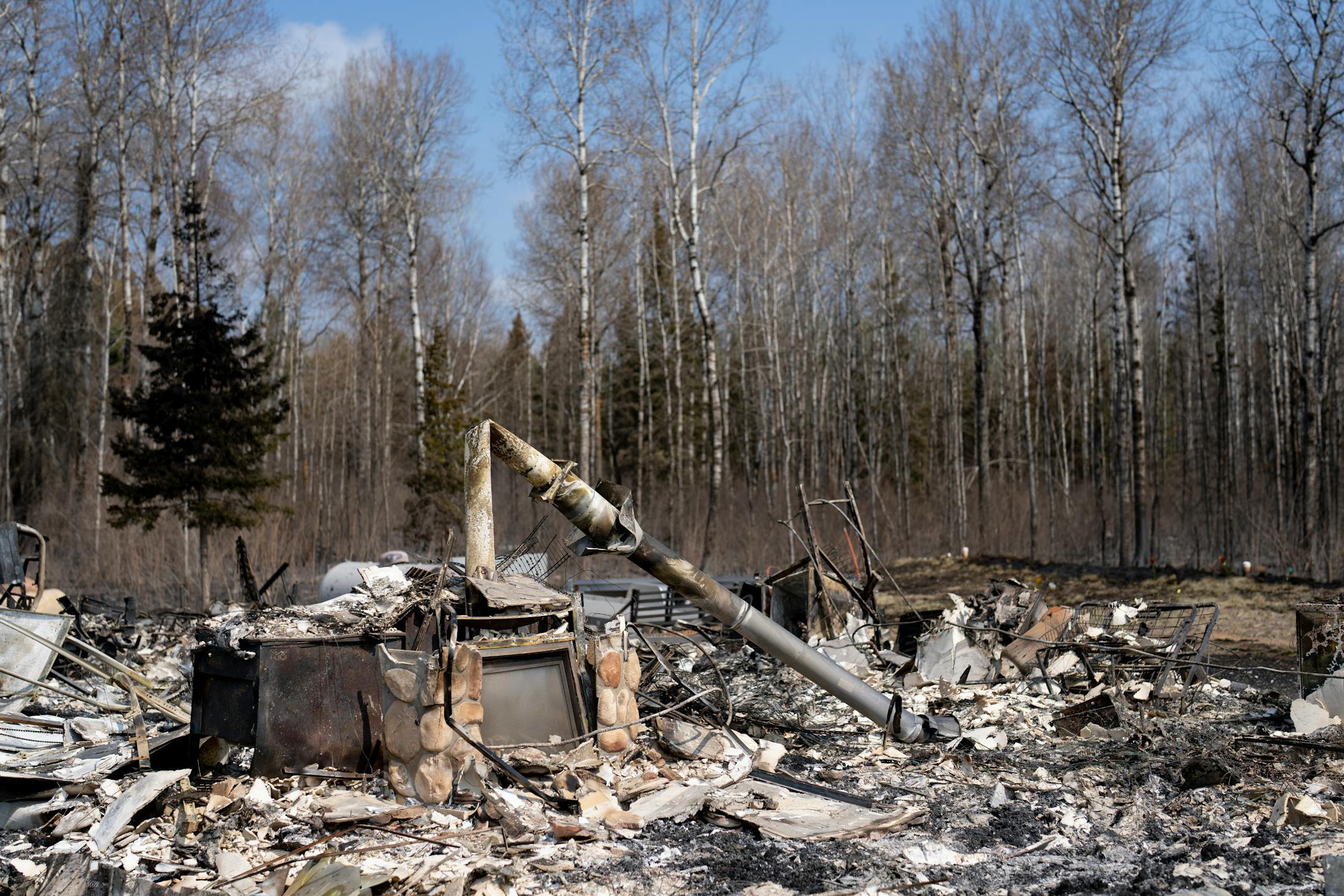 The remains of a structure stand among ruins after being burned down by the Camp House wildfire in Brimson, Minn. on Thursday, May 15, 2025.   ]

ALEX KORMANN • alex.kormann@startribune.com