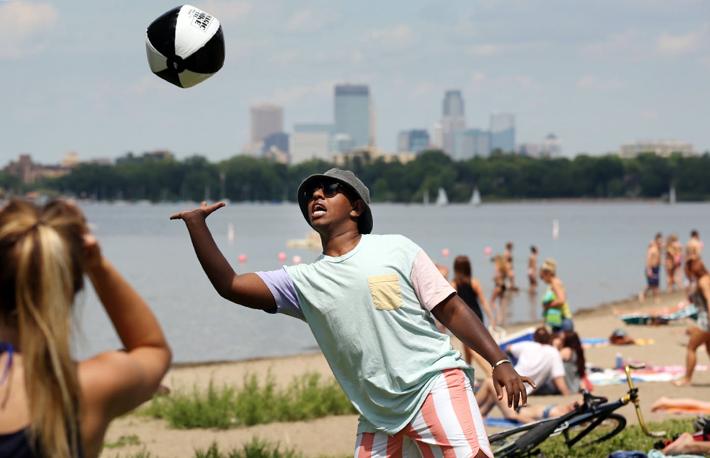 Hope McCracken, left, and Jonathan Ayele played with a beach ball at Lake Calhoun on Tuesday.