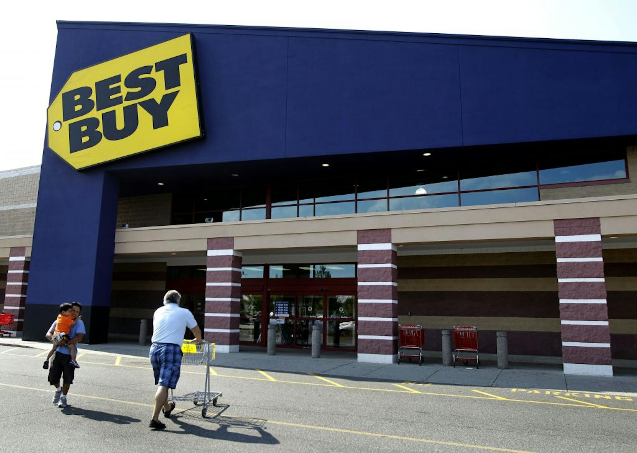 Customers walk in and out of Best Buy in Danvers, Mass.