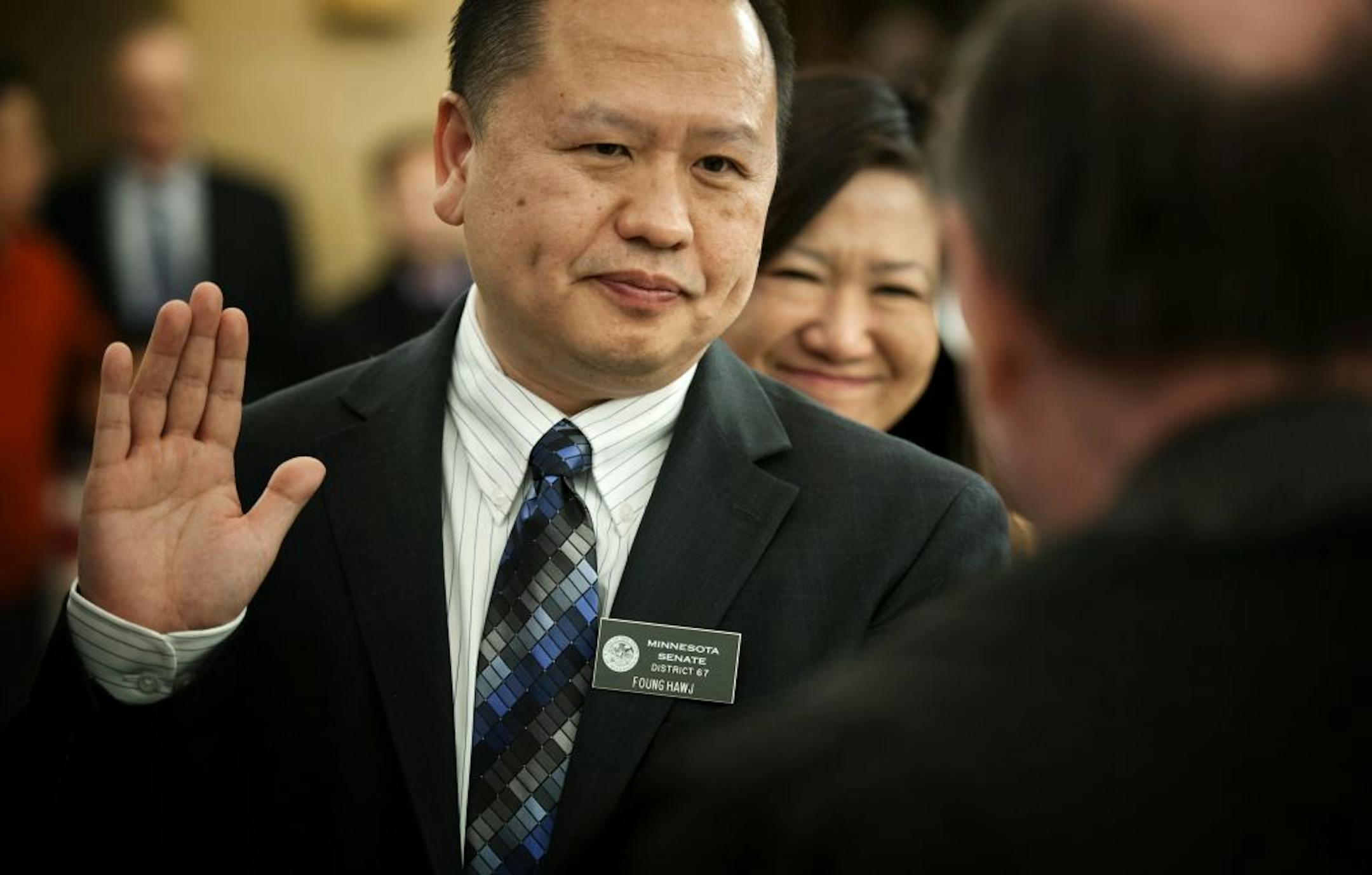 Before he was sworn in on the Senate floor Tuesday, state Sen. Foung Hawj, DFL-St. Paul, posed for a photo. Behind him was his wife, Anna.