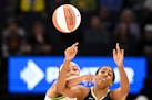 Minnesota Lynx forward Napheesa Collier knocks the ball loose from the hands of Dallas Wings forward Monique Billingsas they battle for a rebound in t