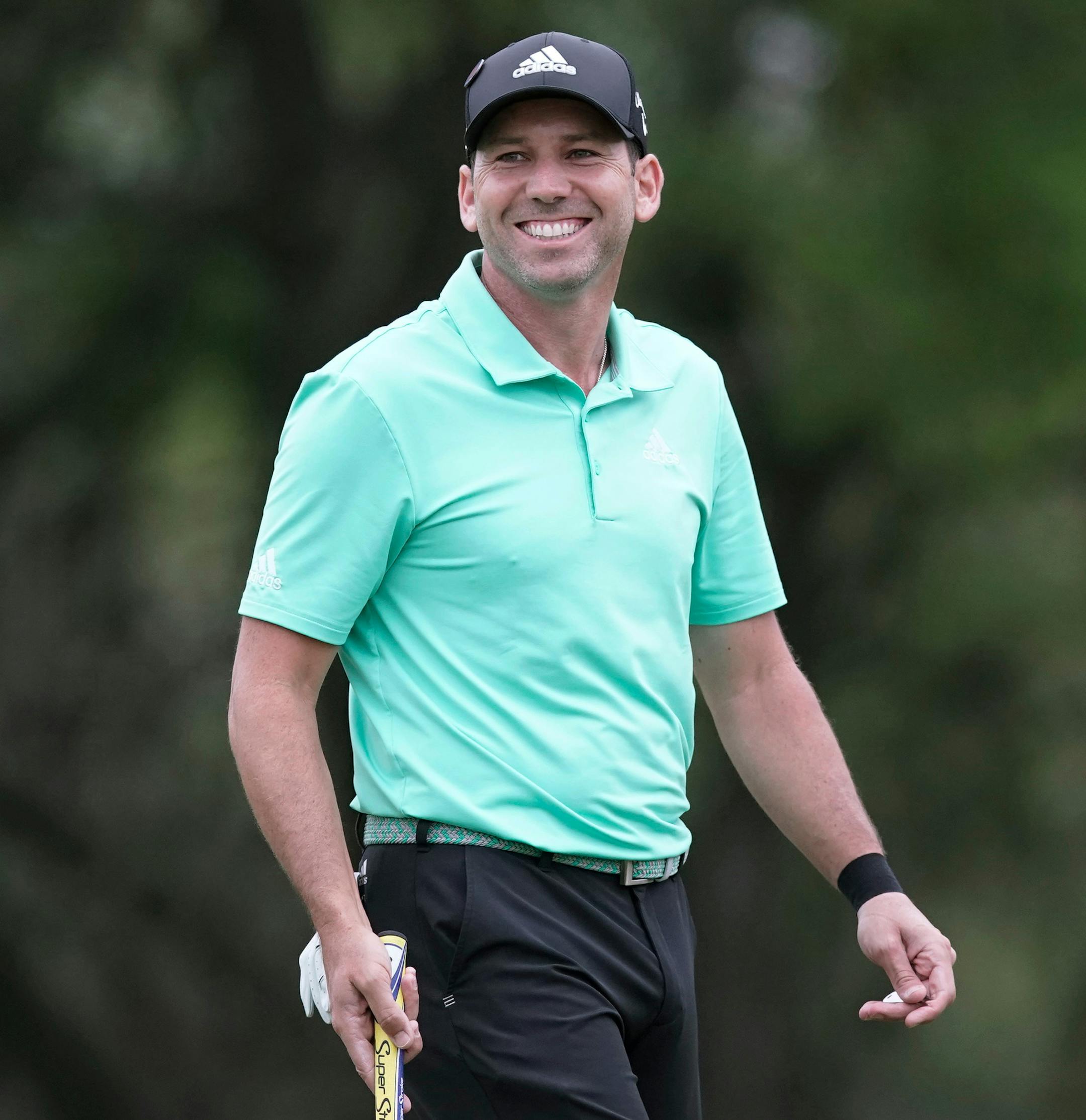 FILE - In this March 24, 2018, file photo, Sergio Garcia smiles as he prepares to putt on the first green during round four at the Dell Technologies Match Play golf tournament, in Austin, Texas. Sergio Garcia has a long history with Texas even before he became a part-time resident. Now, the connection extends to family. He married Angela Akins last summer, and he's based out of the Austin area when he's playing in America. Garcia also has a connection to the Valero Texas Open, where he is expect