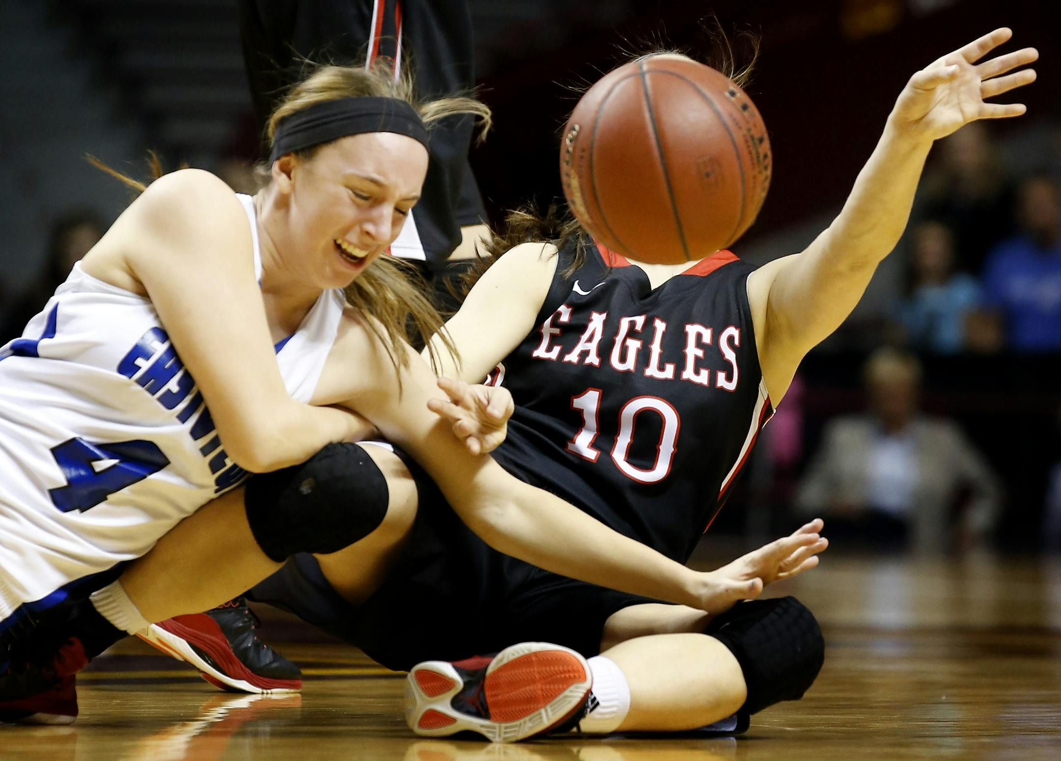 Erika Schlosser (4) of Eastview and Andrea Jirele (10) of Eden Prairie fought for a loose ball in the first half. ] CARLOS GONZALEZ cgonzalez@startribune.com - March 20, 2014 , Minneapolis, Minn., Williams Arena, Class 4A girls' basketball semifinals, Eastview vs. Eden Prairie, 6 p.m.;