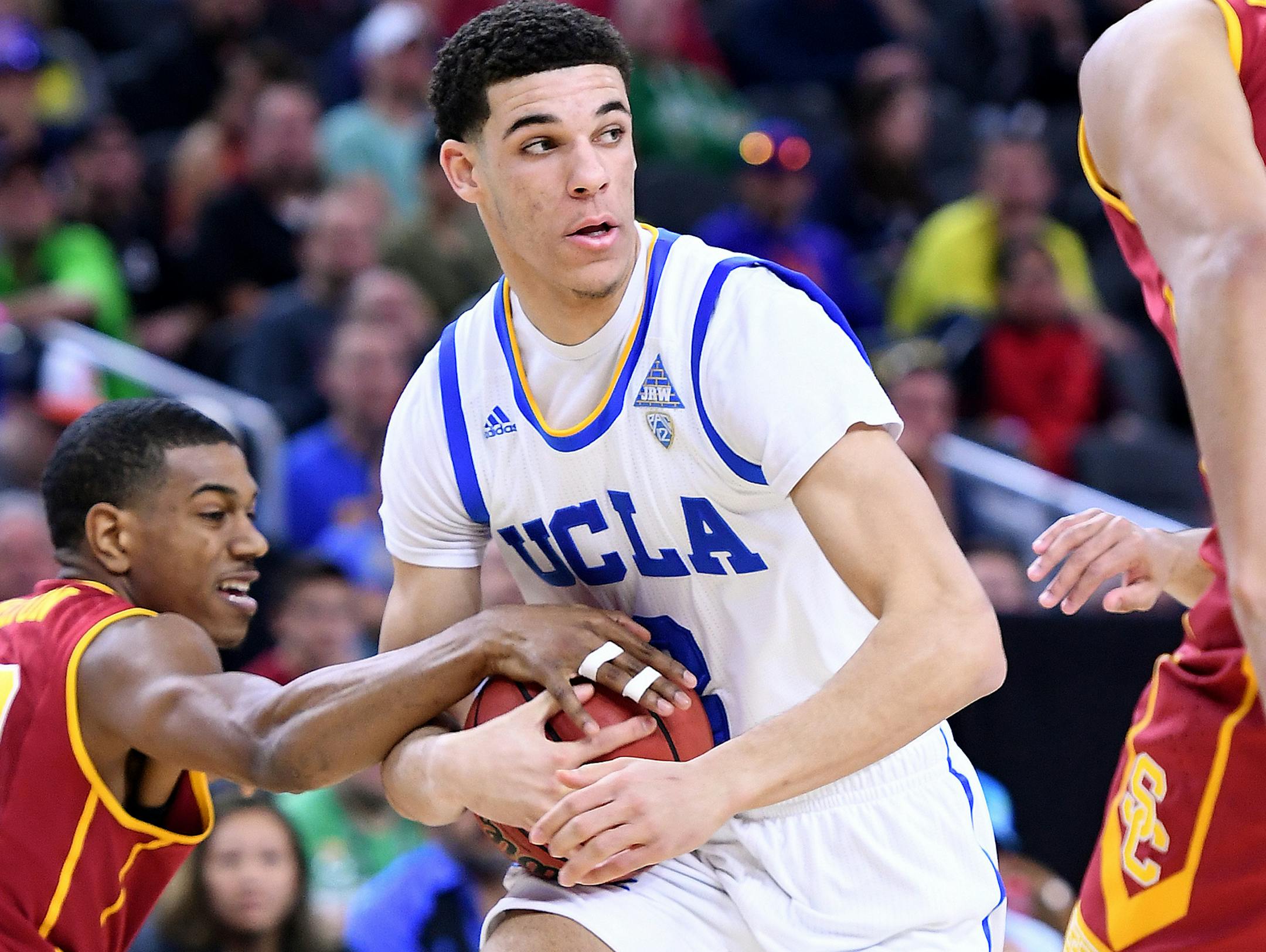 UCLA's Lonzo Ball picks up a loose ball in front of USC's De'Anthony Melton, left, in the first half of the Pac-12 Tournament quarterfinals at the T-Mobile Arena in Las Vegas on Thursday, March 9, 2017. (Wally Skalij/Los Angeles Times/TNS)