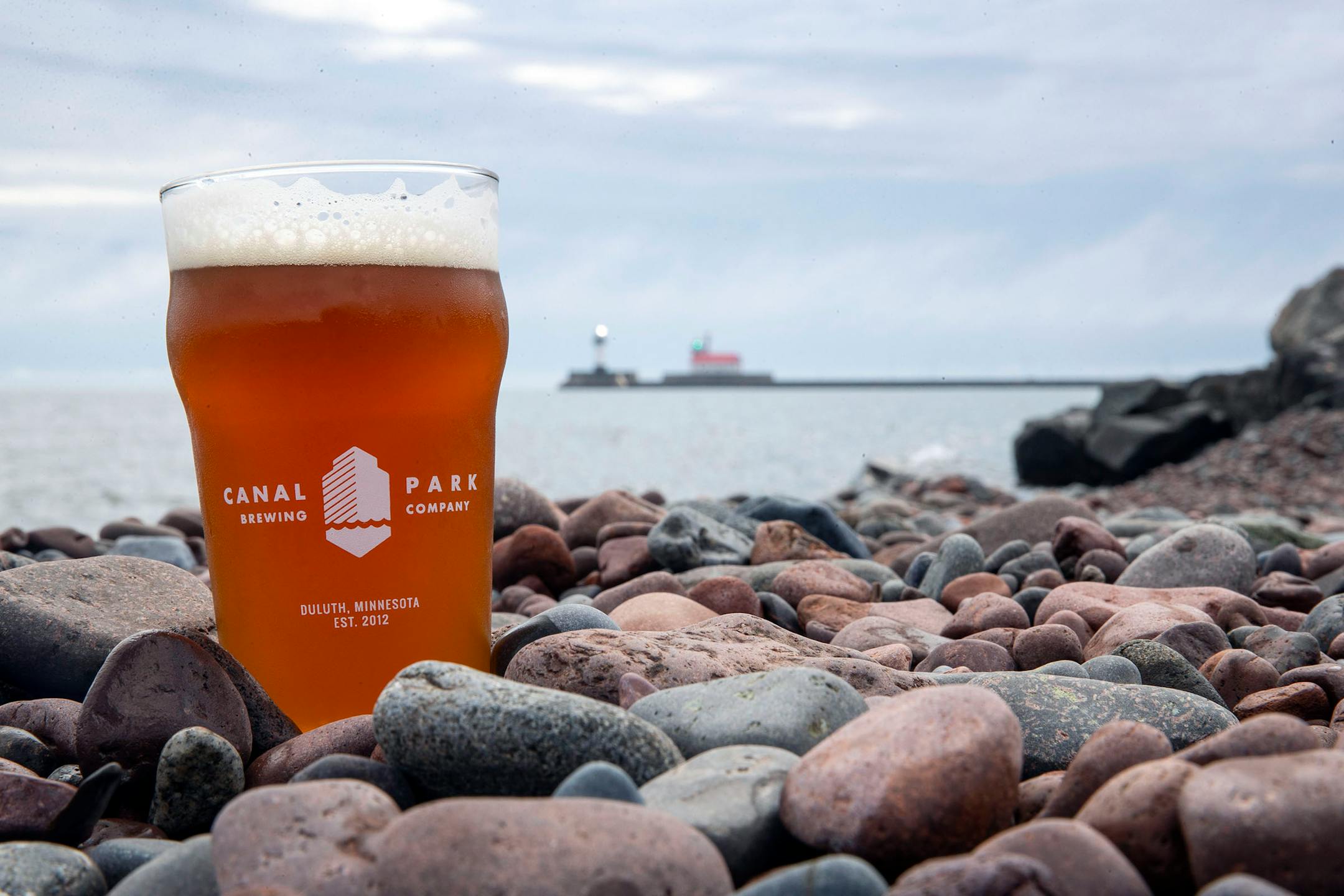 A Canal Park Brewery offering is pictured along the shores of Lake Superior.