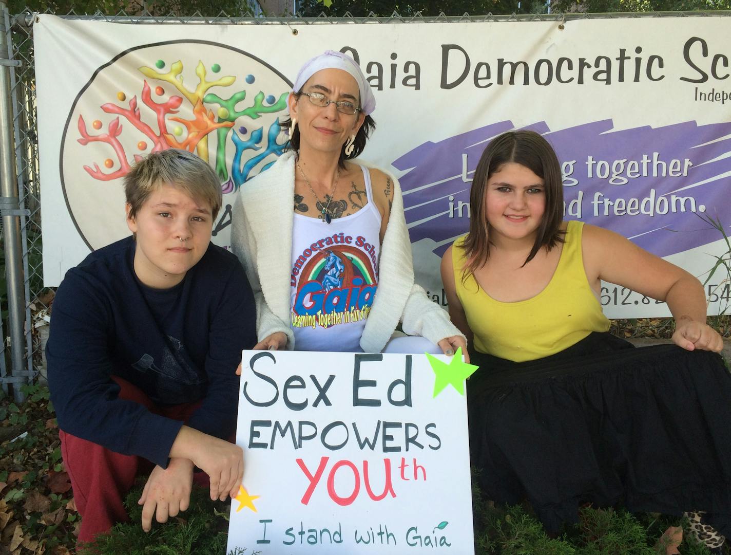 Photo Courtesy of Starri Hedges. Gaia Democratic School Director Starri Hedges and students demonstrate their support for the school after a fieldd trip sparked controversy. Hedges has kicked off a campaign to support sex education for youth.