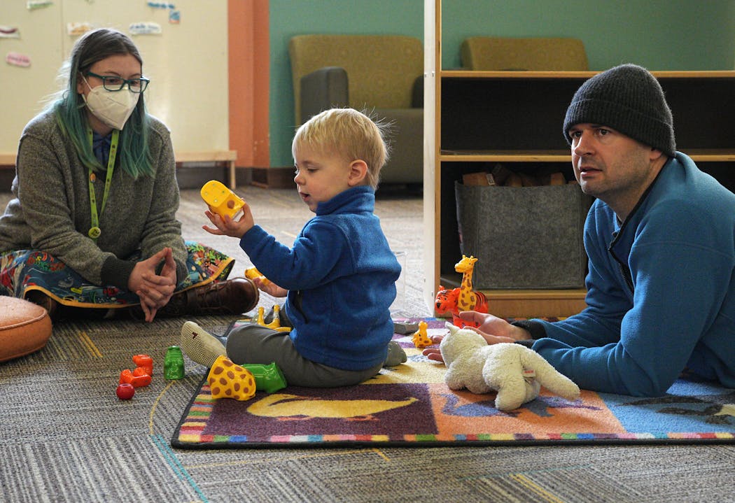 Jon Van Nurden and son, Henrik, 2, enjoy play time at St. Paul’s George Latimer Central Library with library staffer Rhica Hogue on Dec. 22.