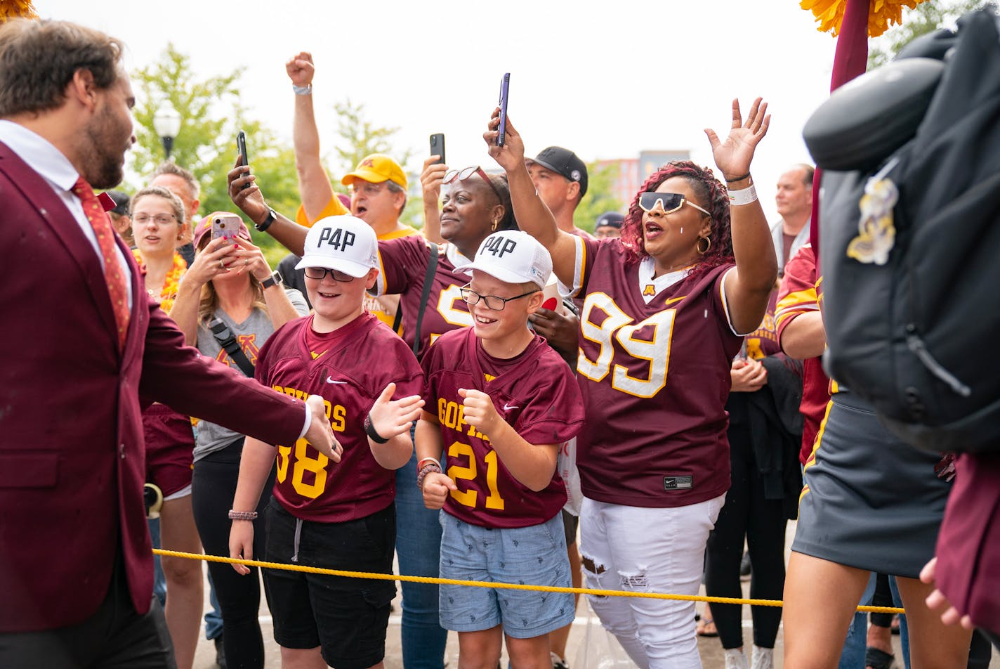 Gophers fans line up to greet the team as they arrive for Saturday's game against Eastern Michigan