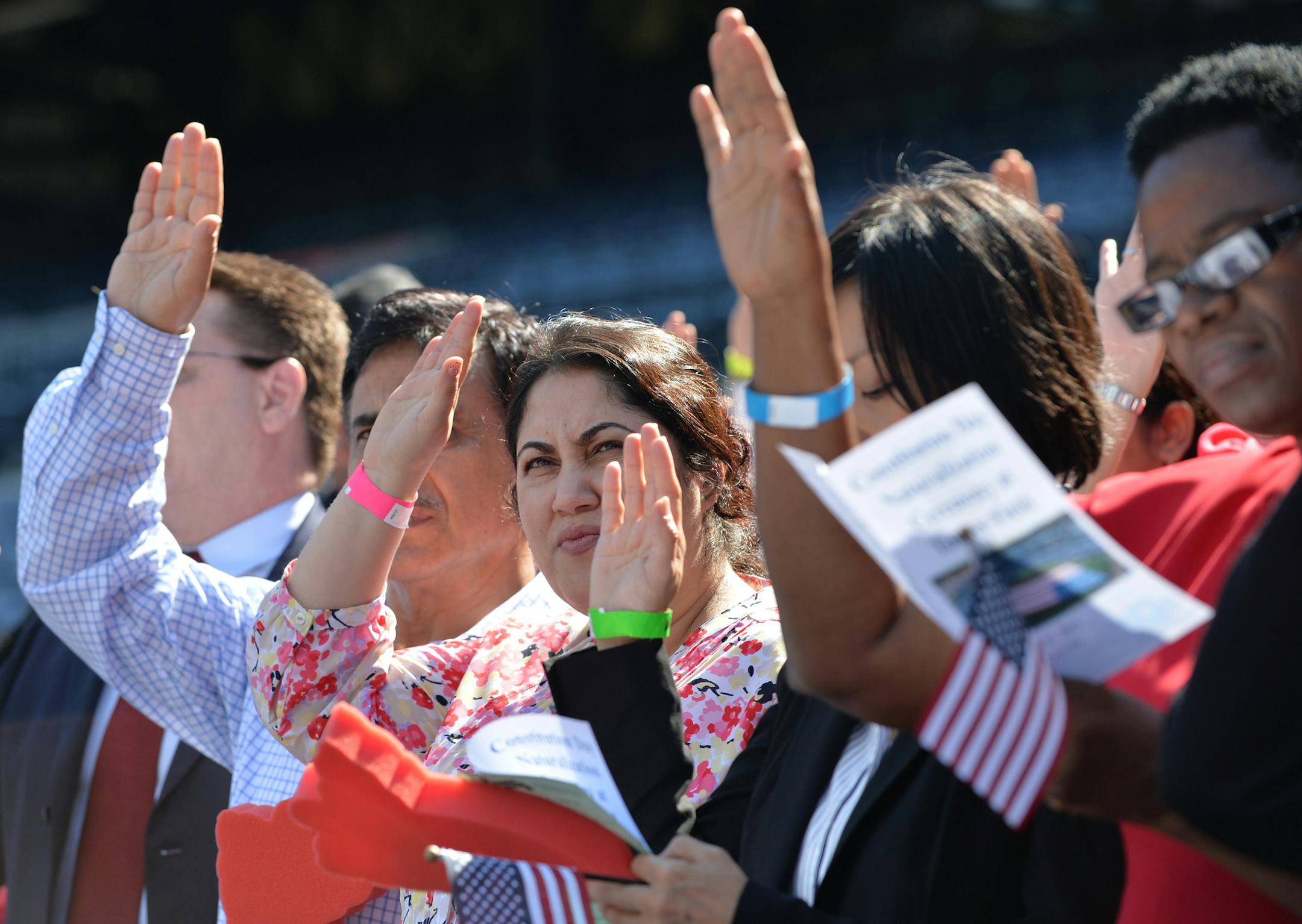 In a special Constitution Day naturalization ceremony at Turner Field, 500 candidates from 93 countries become U.S citizens, Thursday, Sept. 17, 2015 in Atlanta. Atlanta Braves President John Schuerholz delivered remarks during the event and Braves Bullpen Coach and former player Eddie Perez led the crowd in the Pledge of Allegiance. Perez became a naturalized citizen last year. (Brant Sanderlin/Atlanta Journal-Constitution via AP) MARIETTA DAILY OUT; GWINNETT DAILY POST OUT; LOCAL TELEVISION OU