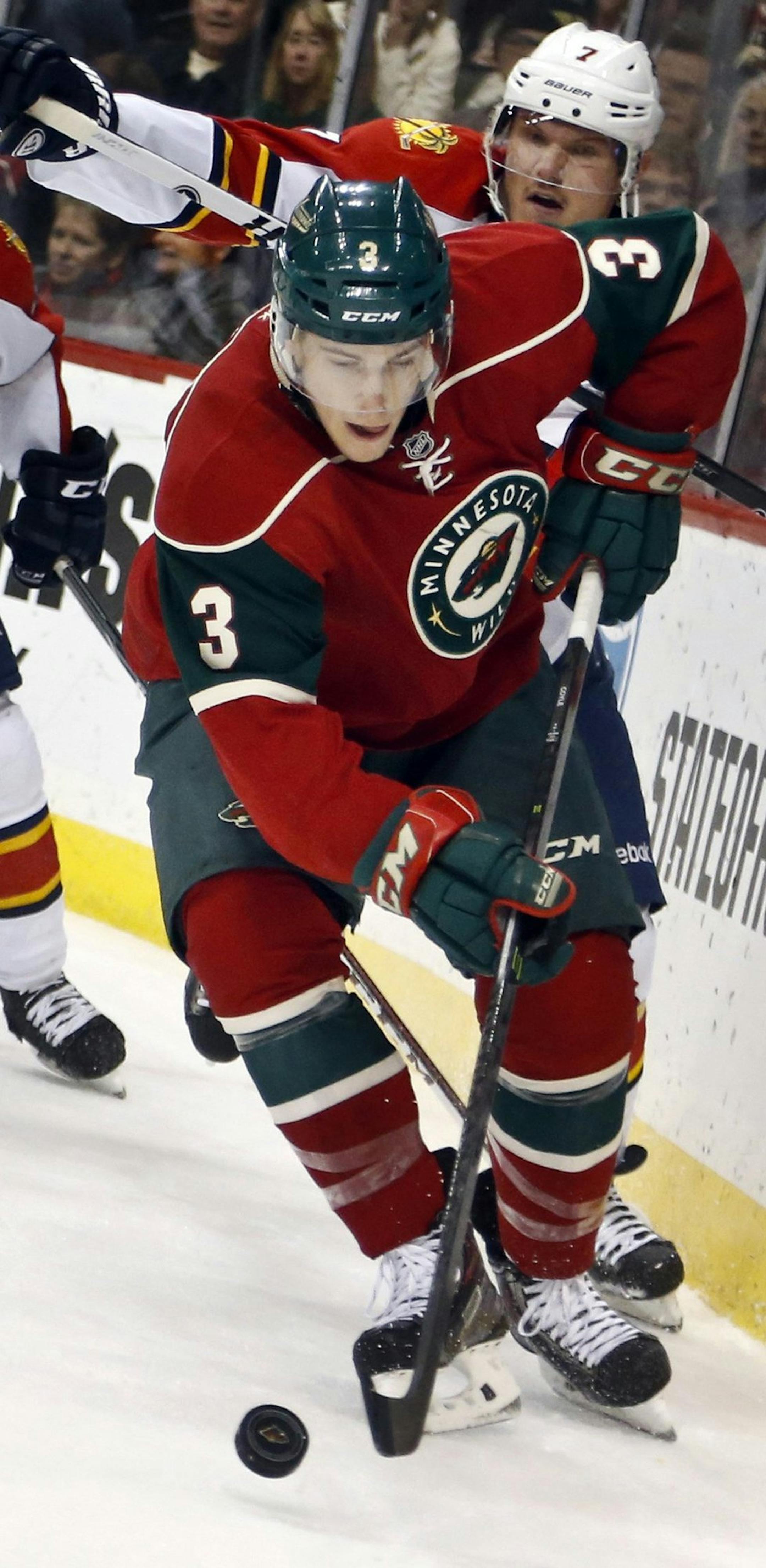 Charlie Coyle of the Minnesota Wild carries the puck with Mike Weaver (43) and Dmitry Kulikov of the Florida Panthers in pursuit in the first period at the Xcel Energy Center in St. Paul, Minn., on Friday, Nov. 15, 2013. The Wild won, 3-2. (David Joles/Minneapolis Star Tribune/MCT) ORG XMIT: 1145672
