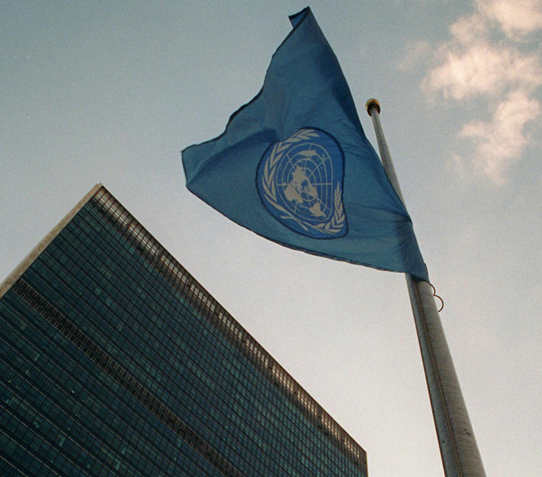 The United Nations flag flys at half staff in front of the Secretariat building, left, in New York Sunday Nov. 5, 1995 out of respect for the late Israeli Prime Minister Yitzhak Rabin who was assasinated in Tel Aviv Saturday. (AP Photo/Mark Lennihan) ORG XMIT: NYR101