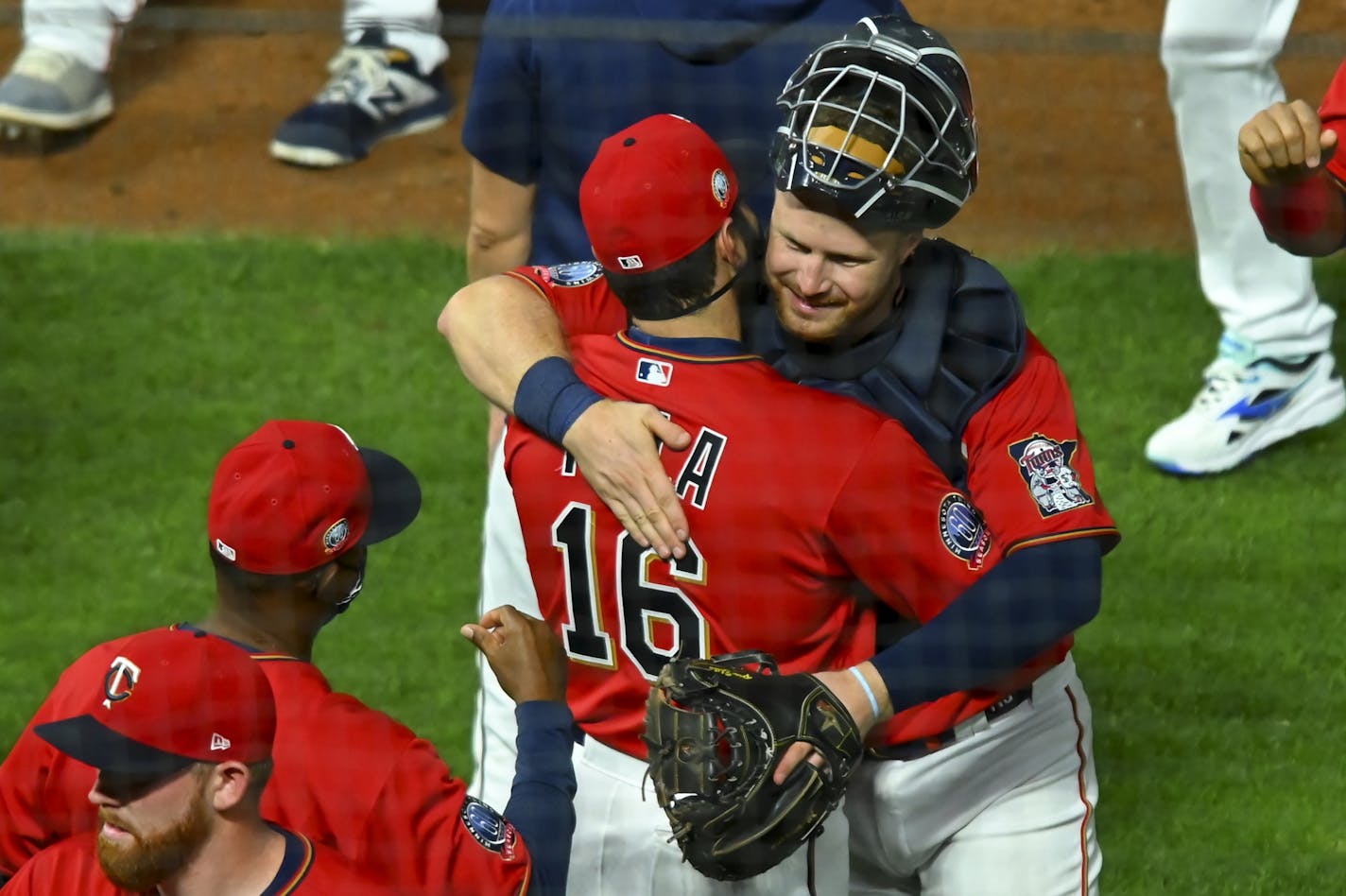 Twins catcher Ryan Jeffers was greeted by teammates and coaches, including fellow catcher Alex Avila (16), after Jeffers' big league debut which included an RBI single and a run scored in the bottom of the eighth inning off a double hit by shortstop Jorge Polanco (11).