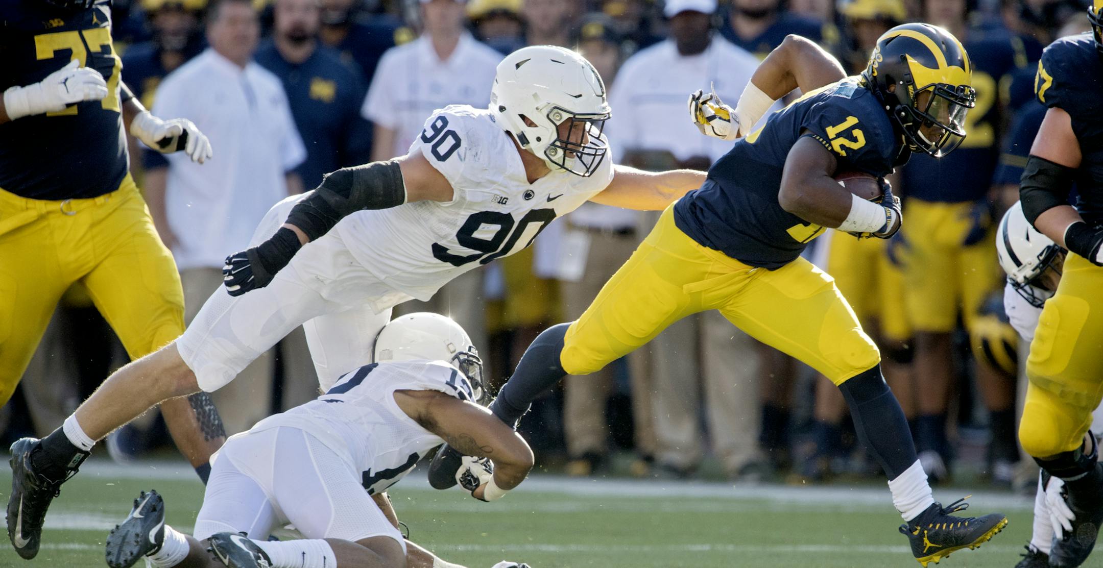 Penn State's Jordan Smith and Garrett Sickles try to stop Michigan running back Chris Evans during an NCAA college football game in Ann Arbor, Mich., Saturday, Sept. 24, 2016. Michigan won 49-10. (Abby Drey/Centre Daily Times via AP)