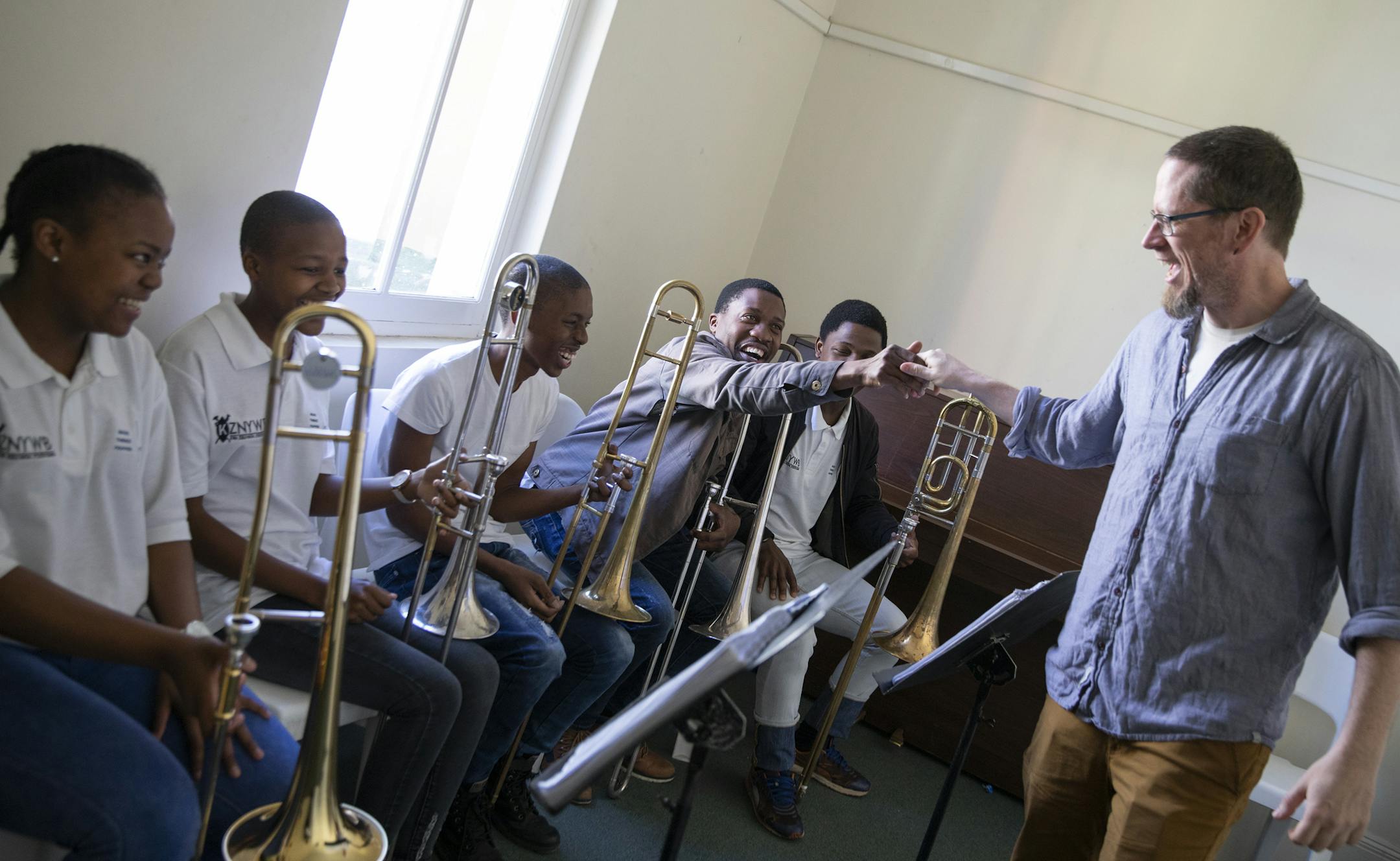 Minnesota Orchestra trombone player Andrew Chappell says goodbye to members of the KwaZulu Natal Youth Wind Band after a breakout session. ] LEILA NAVIDI ï leila.navidi@startribune.com BACKGROUND INFORMATION: A group from the Minnesota Orchestra visits the KwaZulu Natal Youth Wind Band for an engagement activity at Durban Music School in Durban, South Africa on Sunday, August 12, 2018.