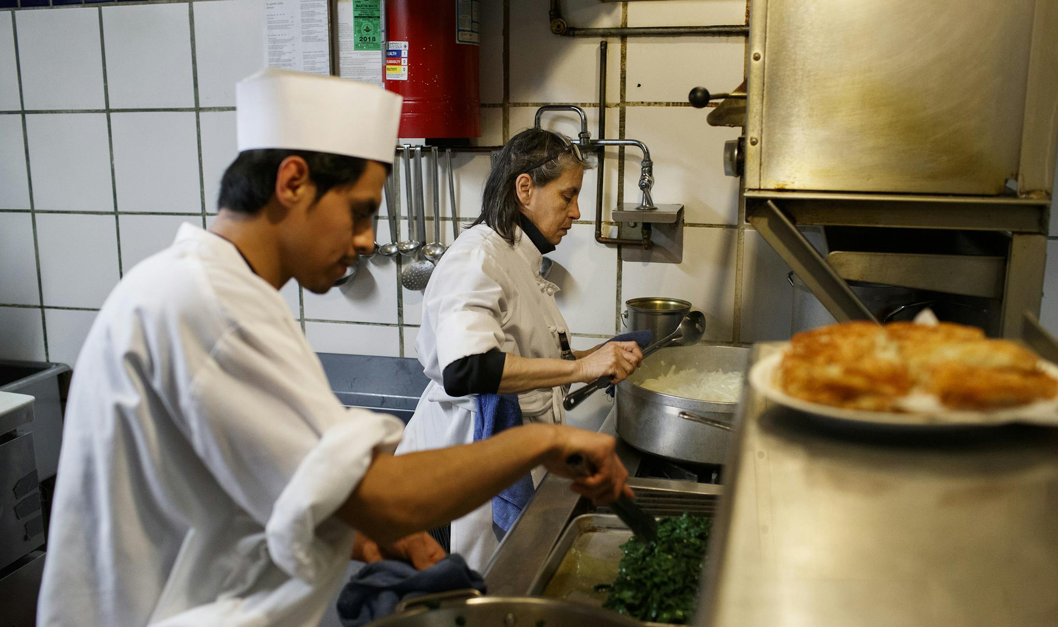 From right, Chef and owner Mary Mastricola and Jose Luis cook in the kitchen at La Petite Folie on December 12, 2018, in Chicago. (Armando L. Sanchez/Chicago Tribune/TNS) ORG XMIT: 1257294