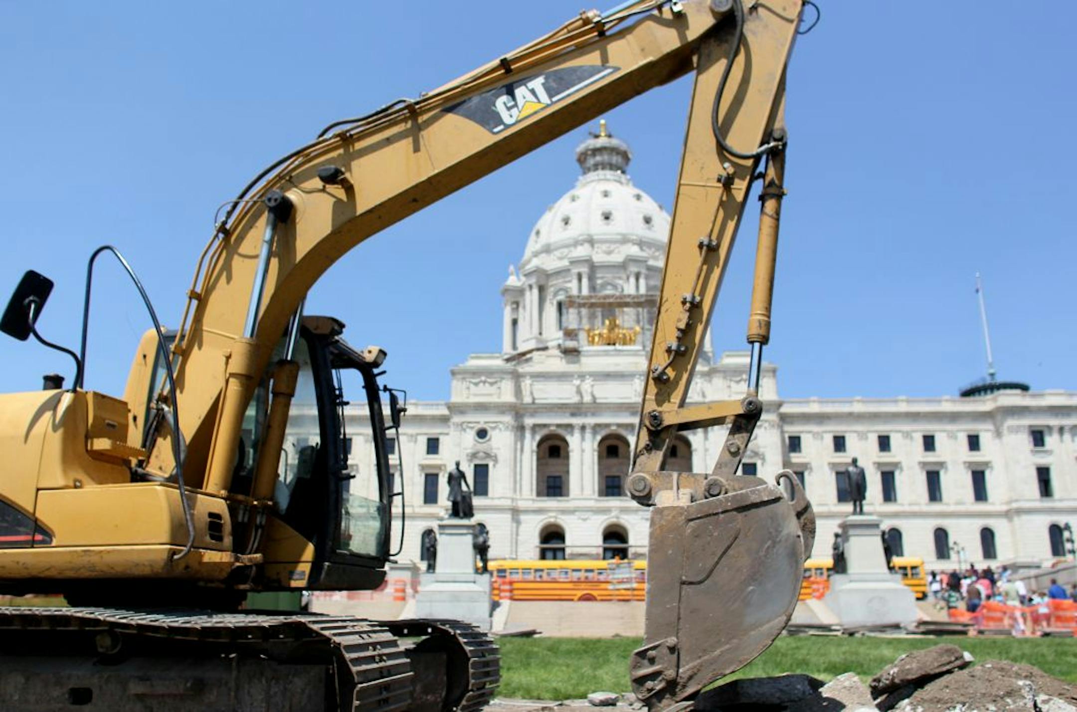 File: A backhoe was parked along sidewalk construction in front of the State Capitol.