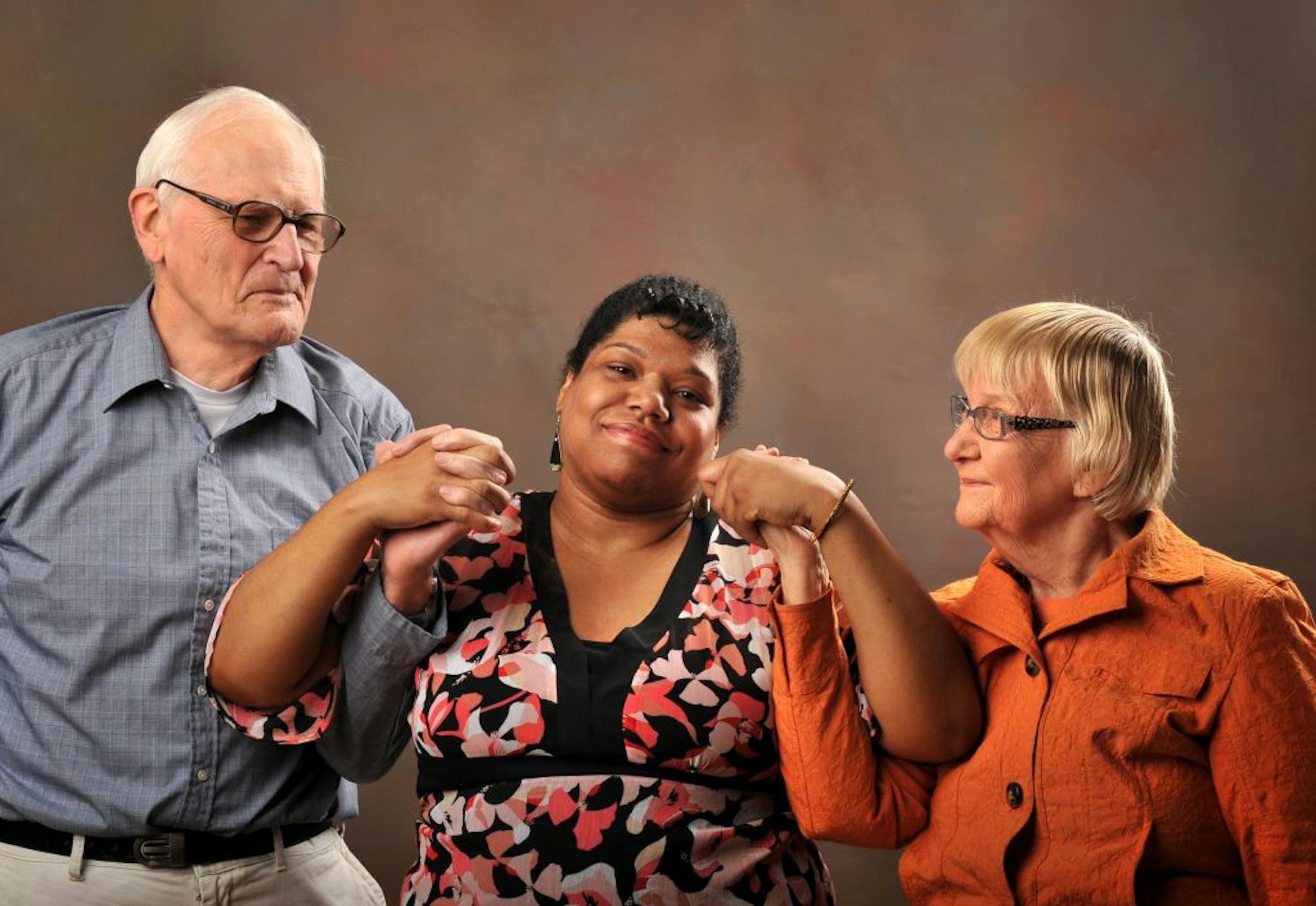 Michelle K. Johnson, center, who was raised by Fred and Ethel Johnson, is an adviser with a new program that gives adoptees a place to share their stories.