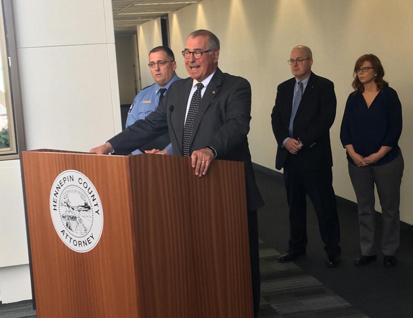 Police Cmdr. Bruce Folkens flanked Hennepin County Attorney Mike Freeman during a news conference announcing the charges against an alleged serial rapist.